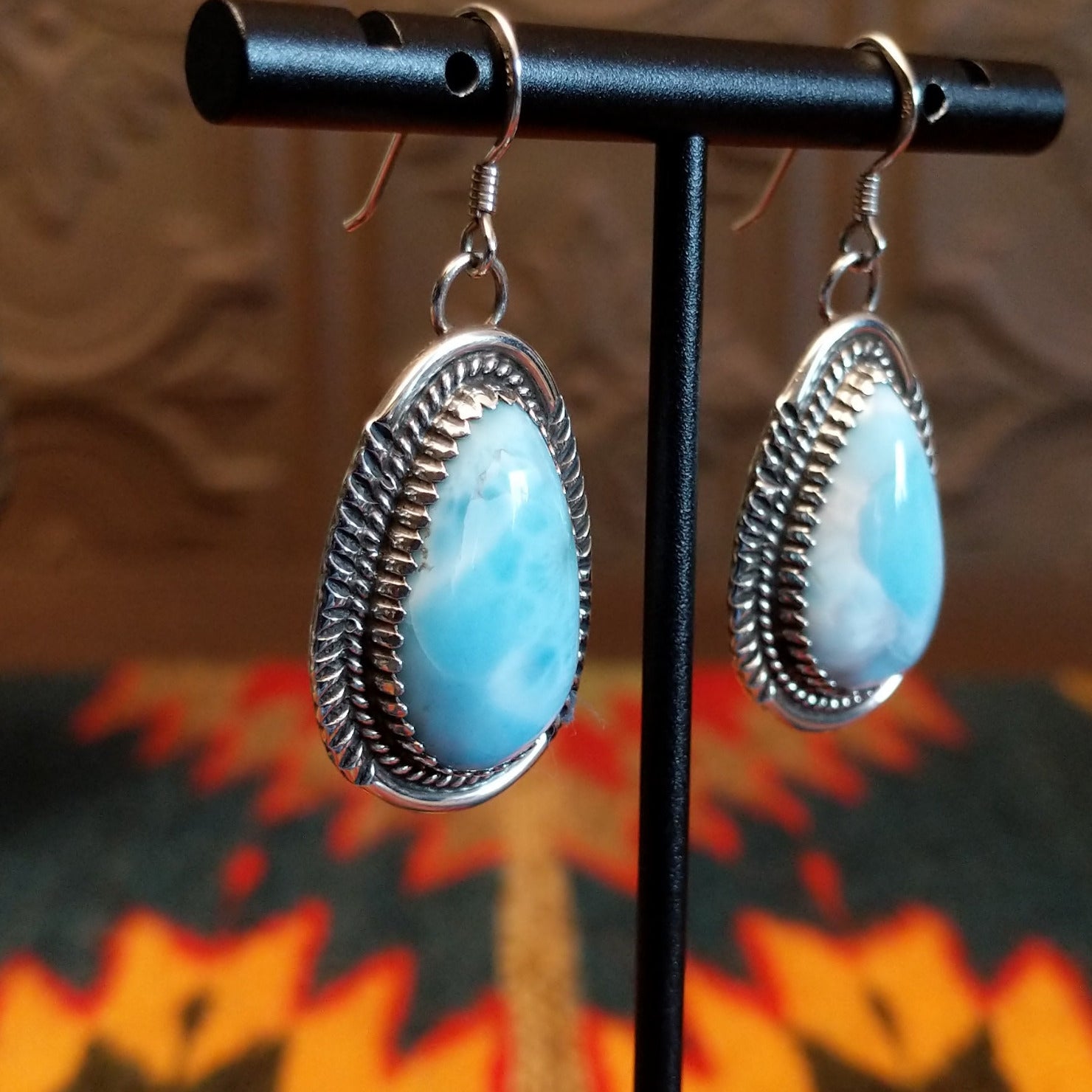 Sterling silver earrings with larimar set in geometric bezels, framed by twisted rope and stamped accents.