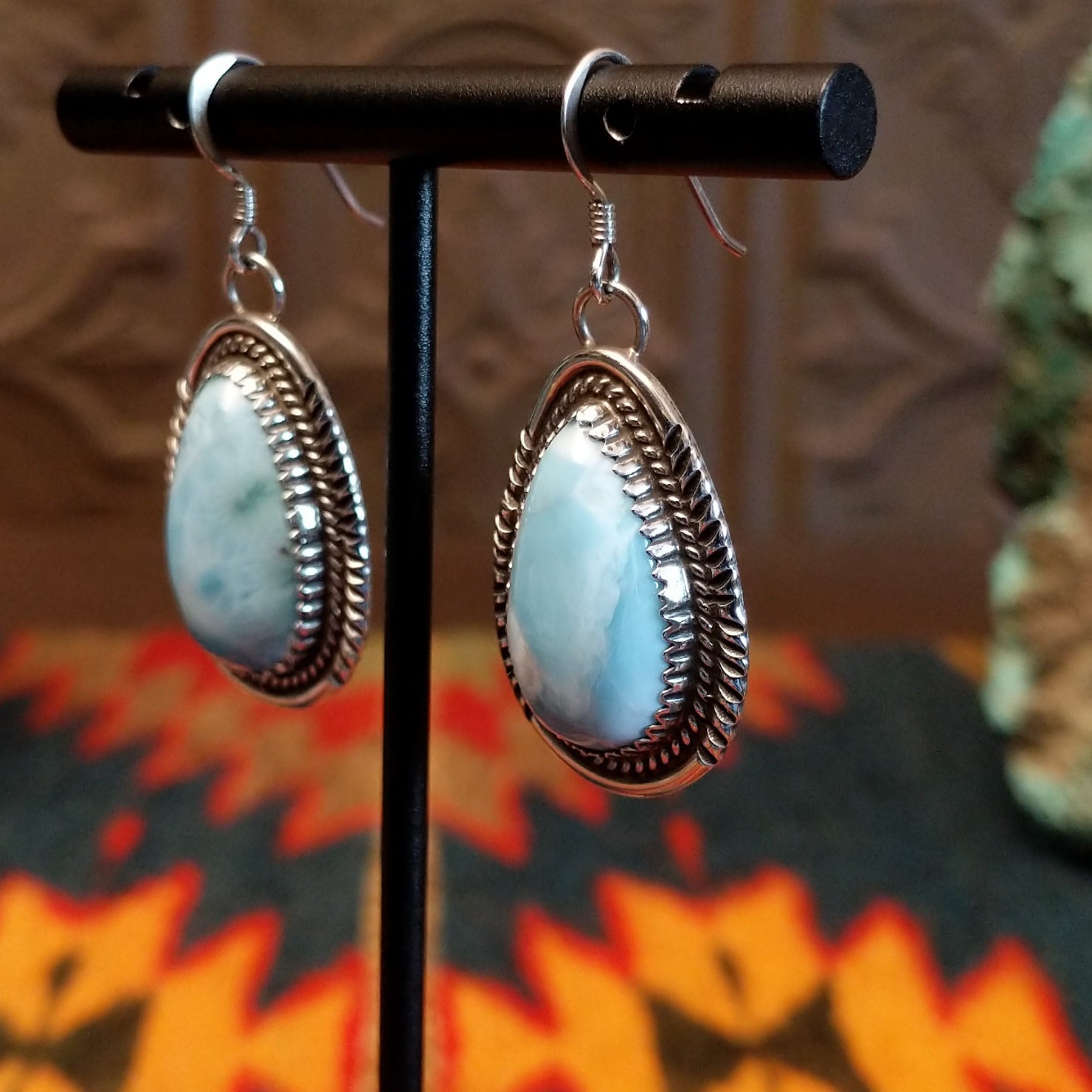 Sterling silver earrings with larimar set in geometric bezels, framed by twisted rope and stamped accents.