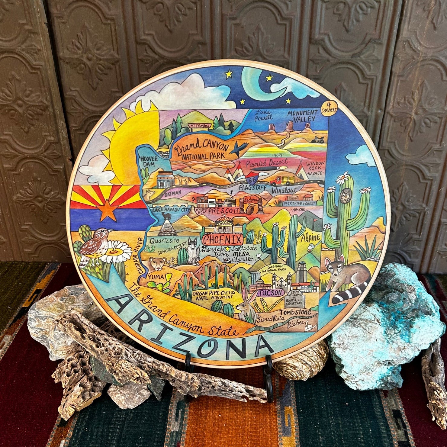 Wooden lazy susan with decorative designs such as with Arizona state colored in with various desert motifs in vibrant colors.