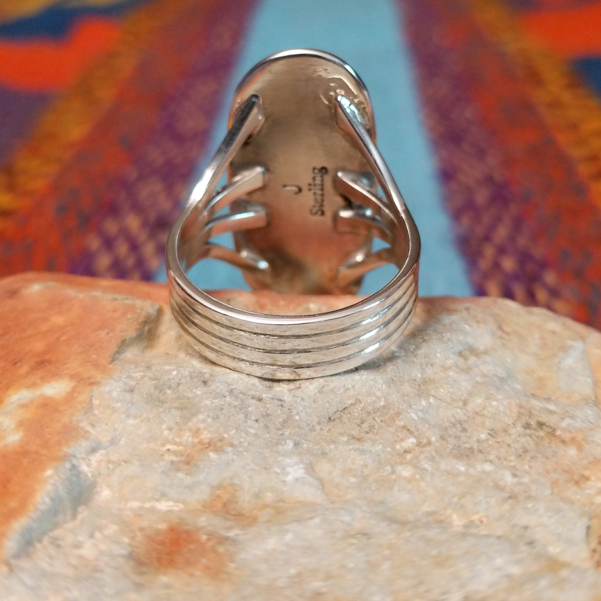 Long Oval Wild Horse Ring by John King featuring a large Wild Horse stone with brown, rust, cream, and white matrix set in Sterling Silver with detailed silverwork and a split-shank band; underside view.