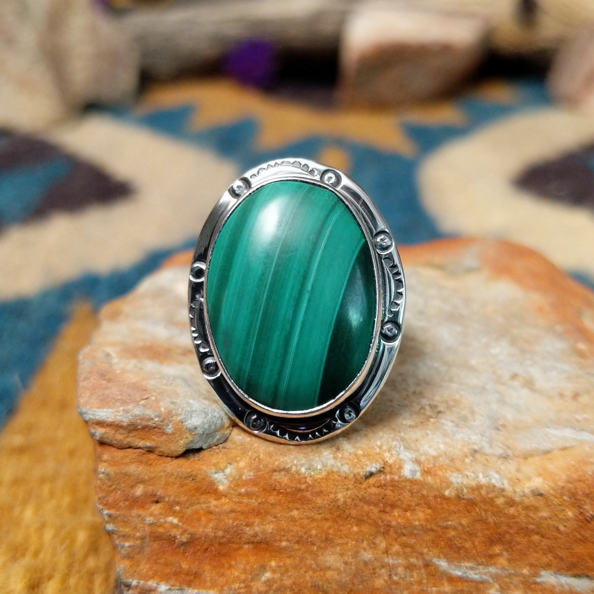 Sterling silver Malachite ring by Terry Wood featuring an oval green stone with natural banding.