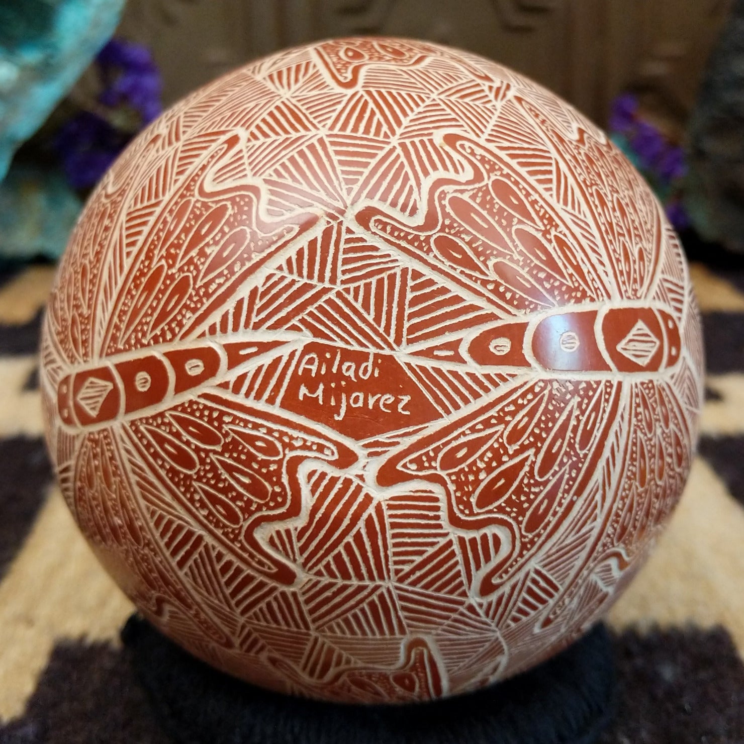 Close up of the artist's engraved signature.