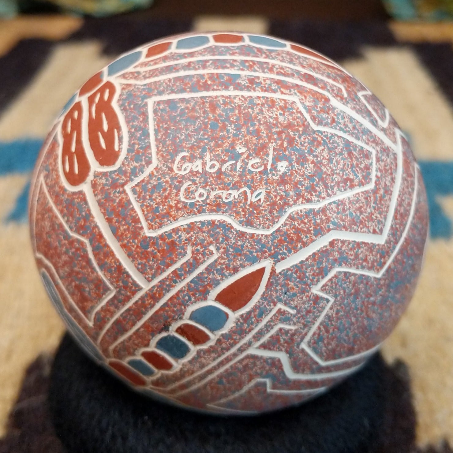 Close up of the artist's engraved signature.