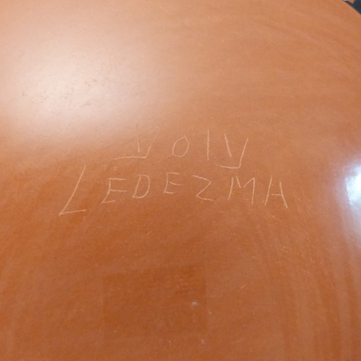Close up of the artist's engraved signature.
