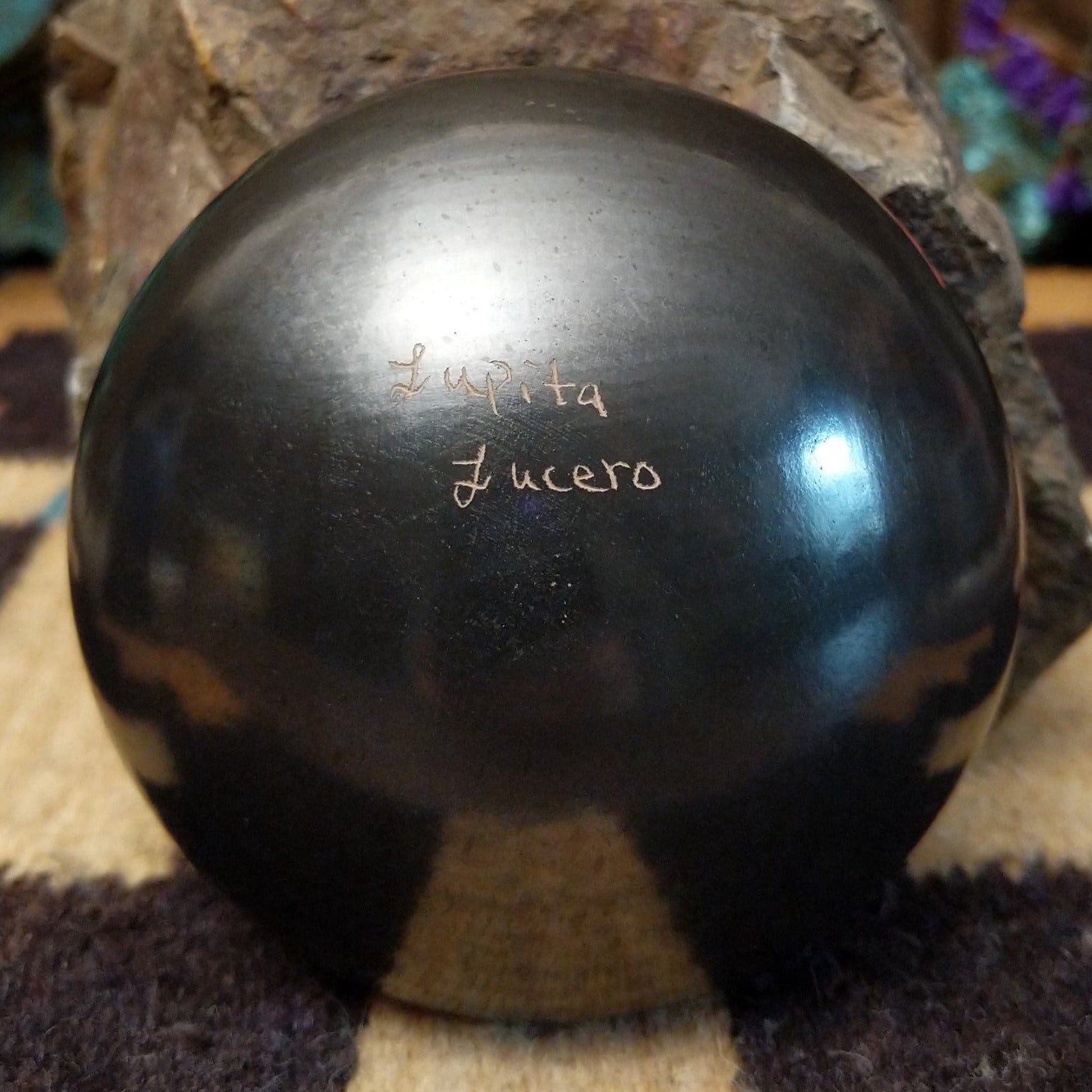 Close up of the artist's engraved signature.