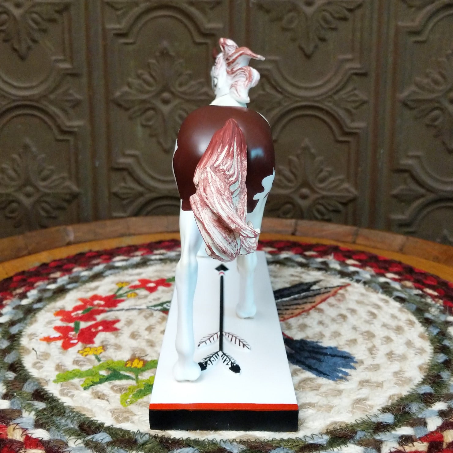 "Medicine Hat" collectible pony by The Trail of Painted Ponies, featuring intricate hand-painted designs, vibrant colors, and traditional Western-inspired artwork. Rear view.