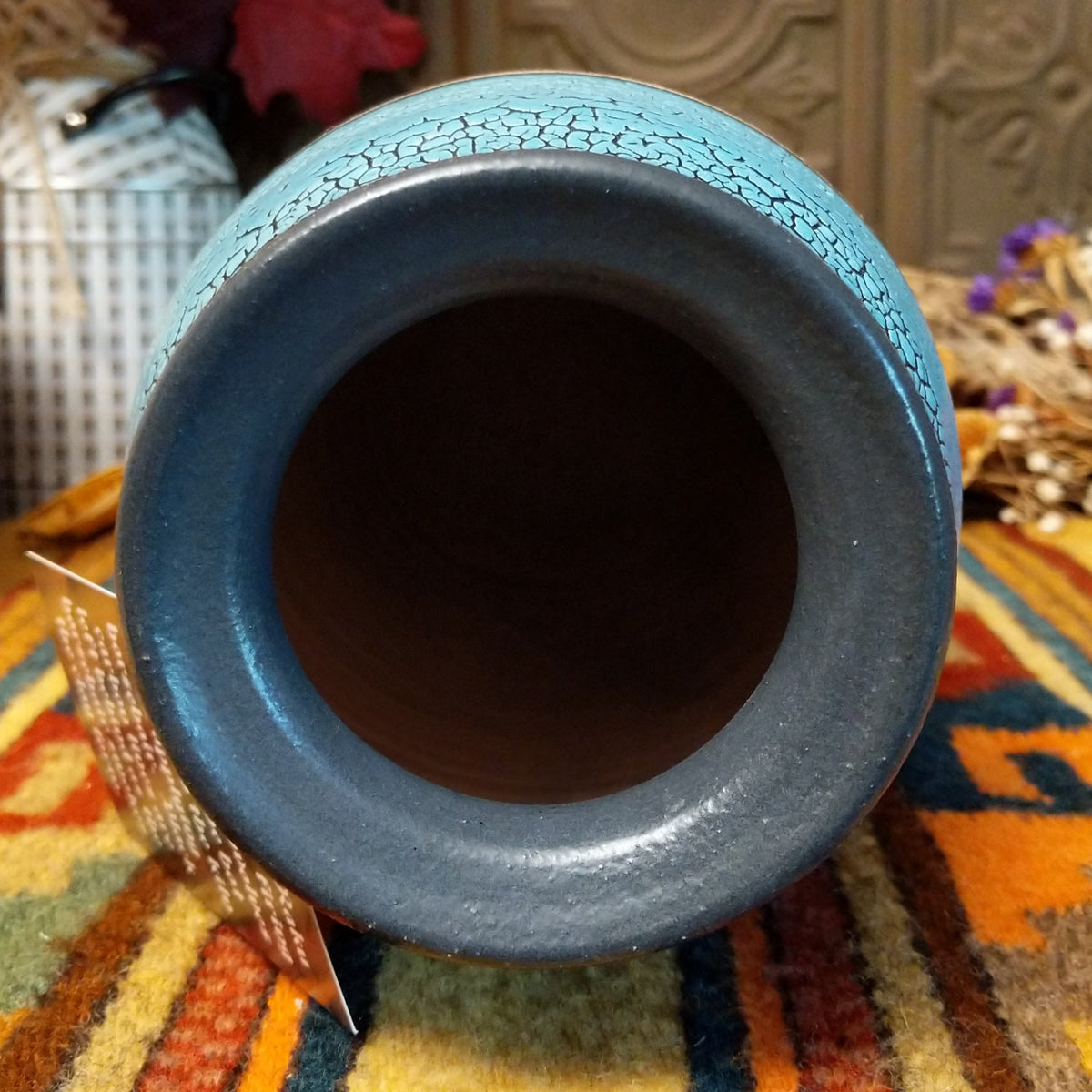 Tall cylindrical horsehair pottery vase by Roger Calhoun with a black rim, crackled turquoise-blue upper section, and branching black horsehair markings on a cream-colored body.