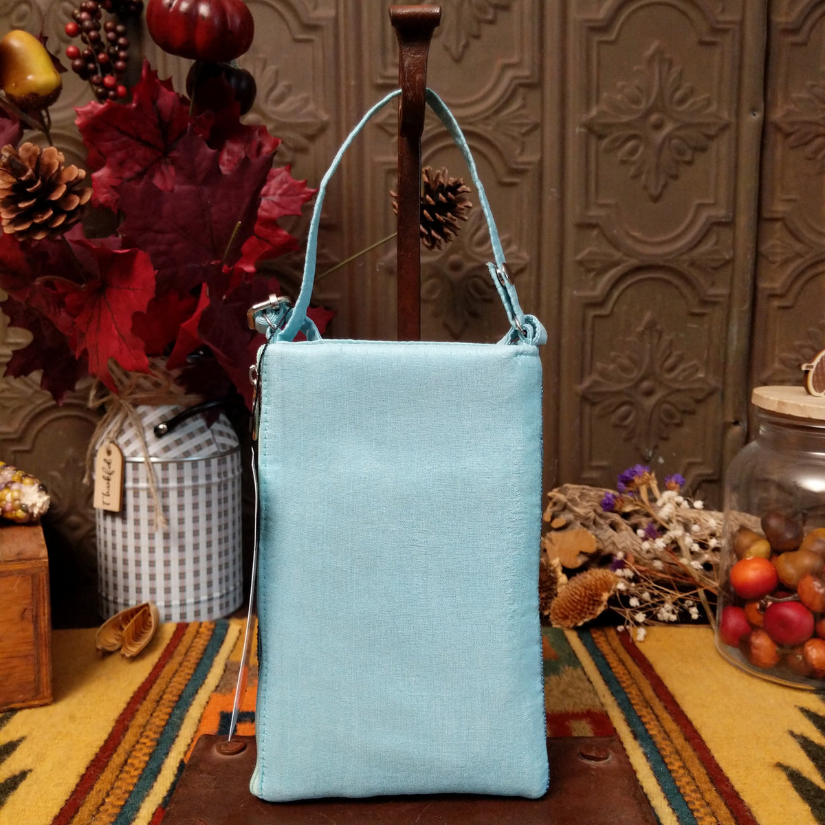 Sparkling Martini Club Bag by Bamboo Trading featuring a colorful beaded martini glass with an olive, shimmering aqua and white sequins, intricate embroidery, and a coordinating shoulder strap; back side.