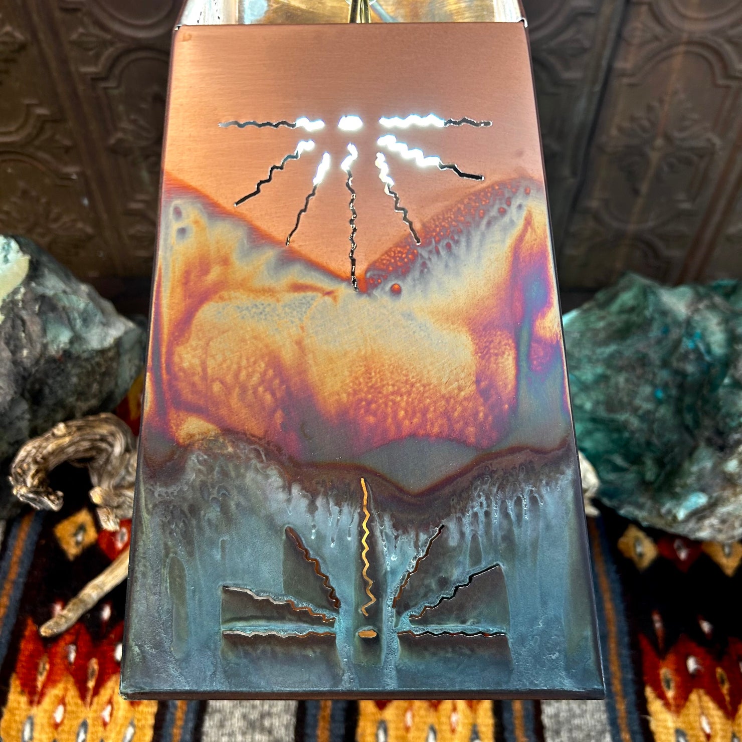 Oxidized copper finish of the lamp's shade featuring stunning cutouts.