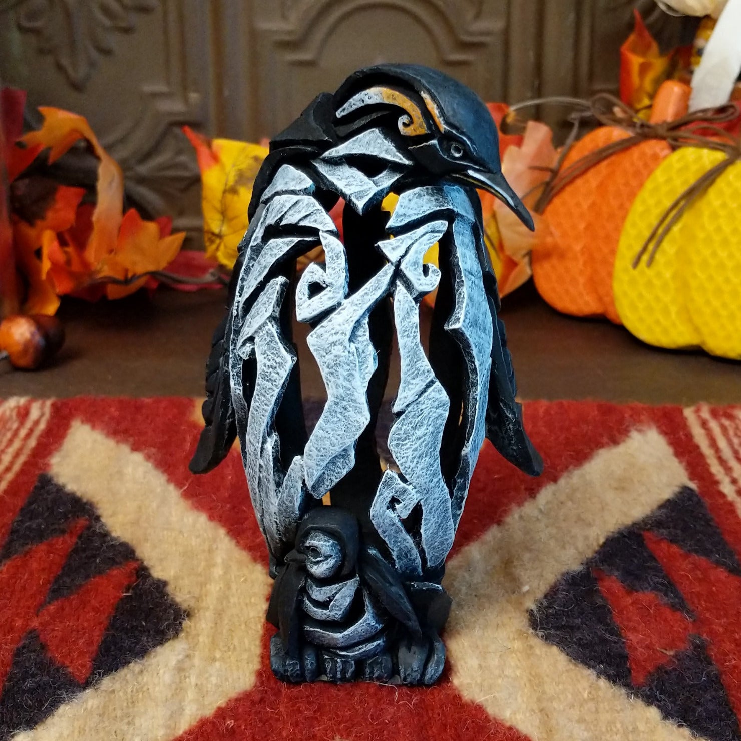 Cast marble used to create a penguin with a baby penguin at the feet.