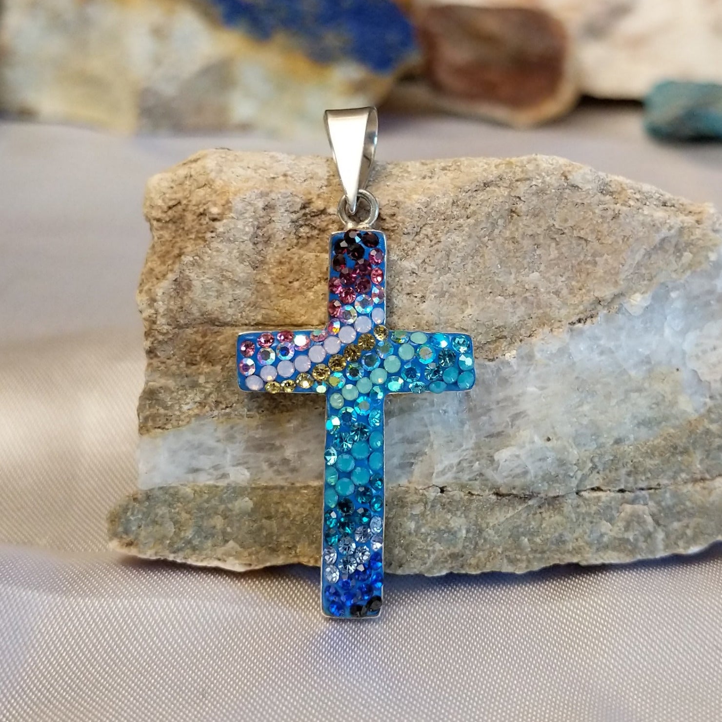 Sterling silver cross pendant with multicolored Austrian crystals.