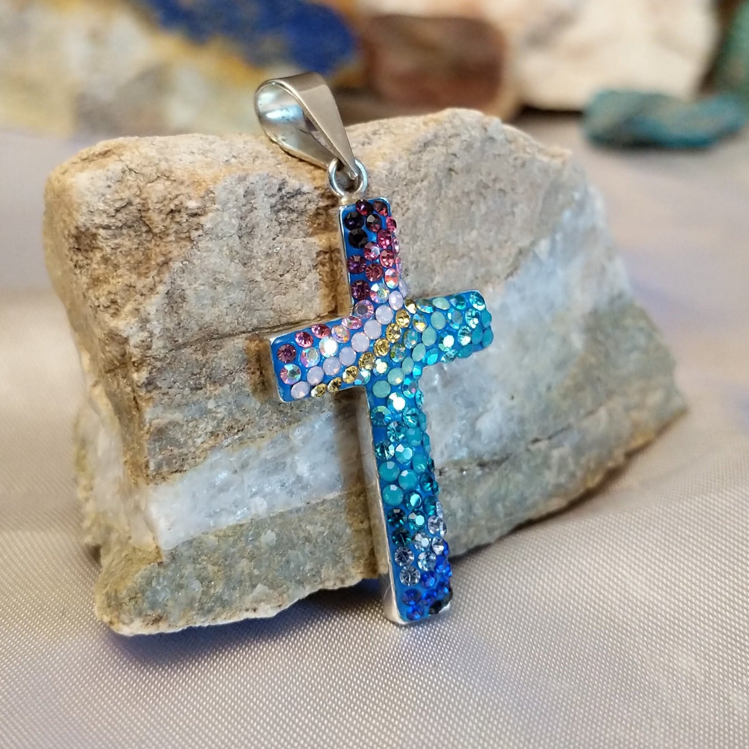 Sterling silver cross pendant with multicolored Austrian crystals.