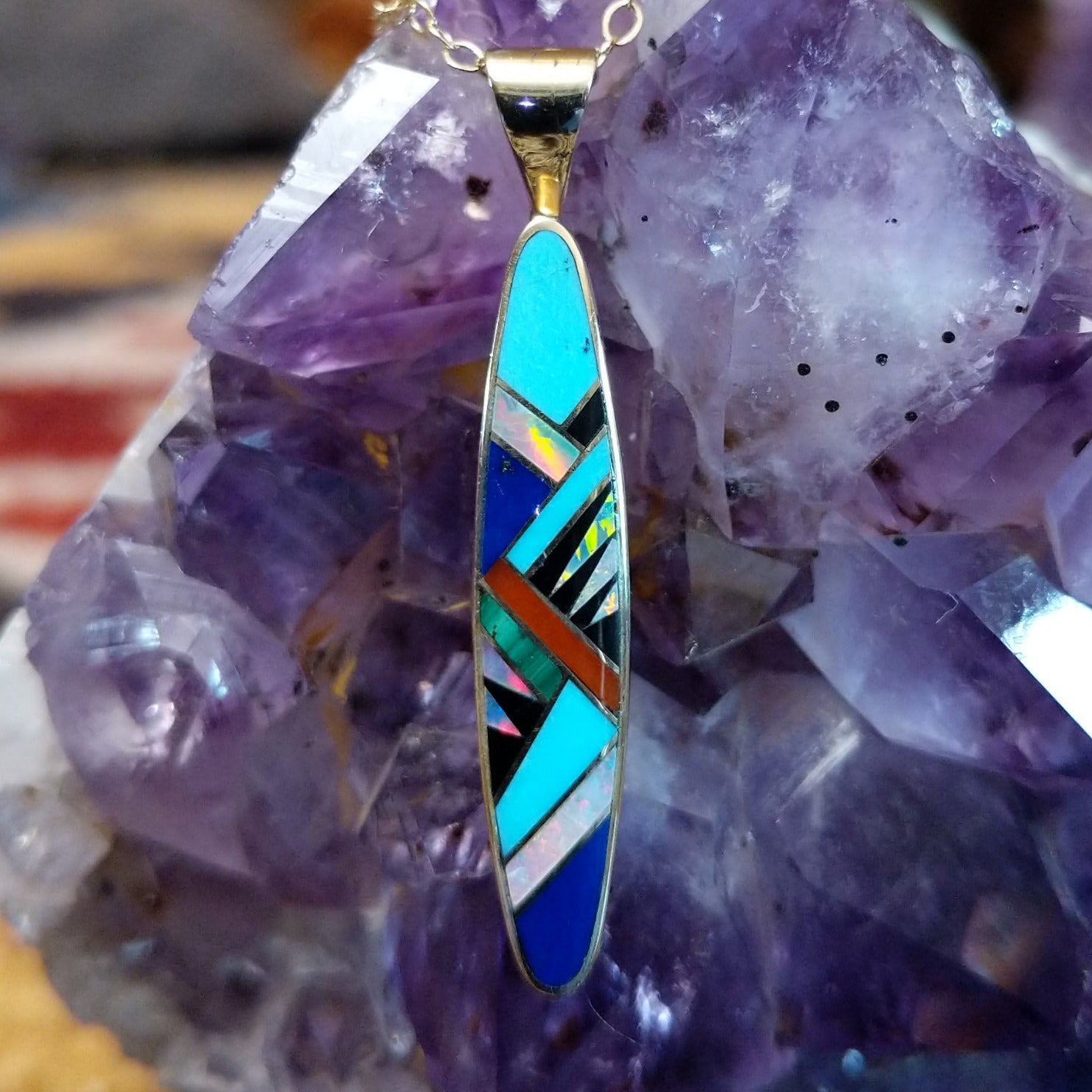 14kt gold Steve Francisco navette pendant with elongated geometric multistone inlay.
