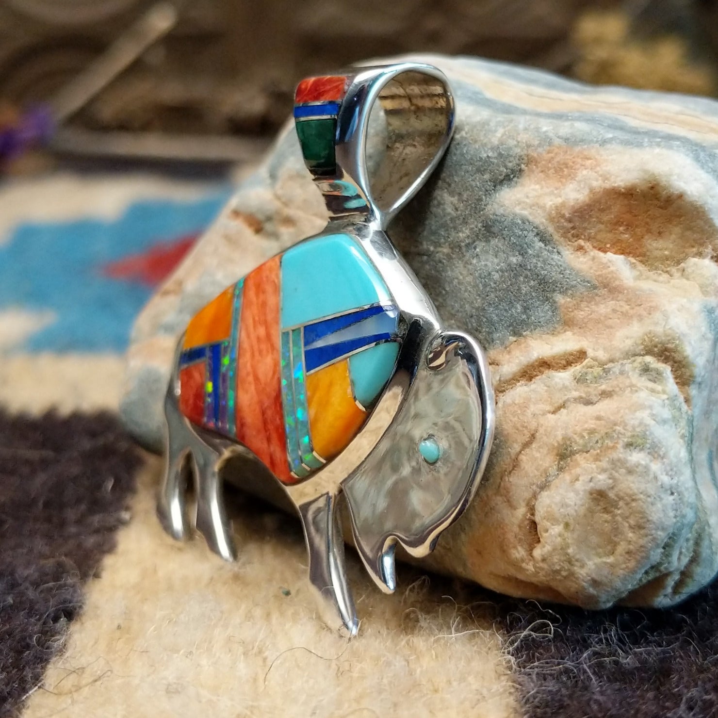 Sterling silver buffalo pendant with multistone inlay.
