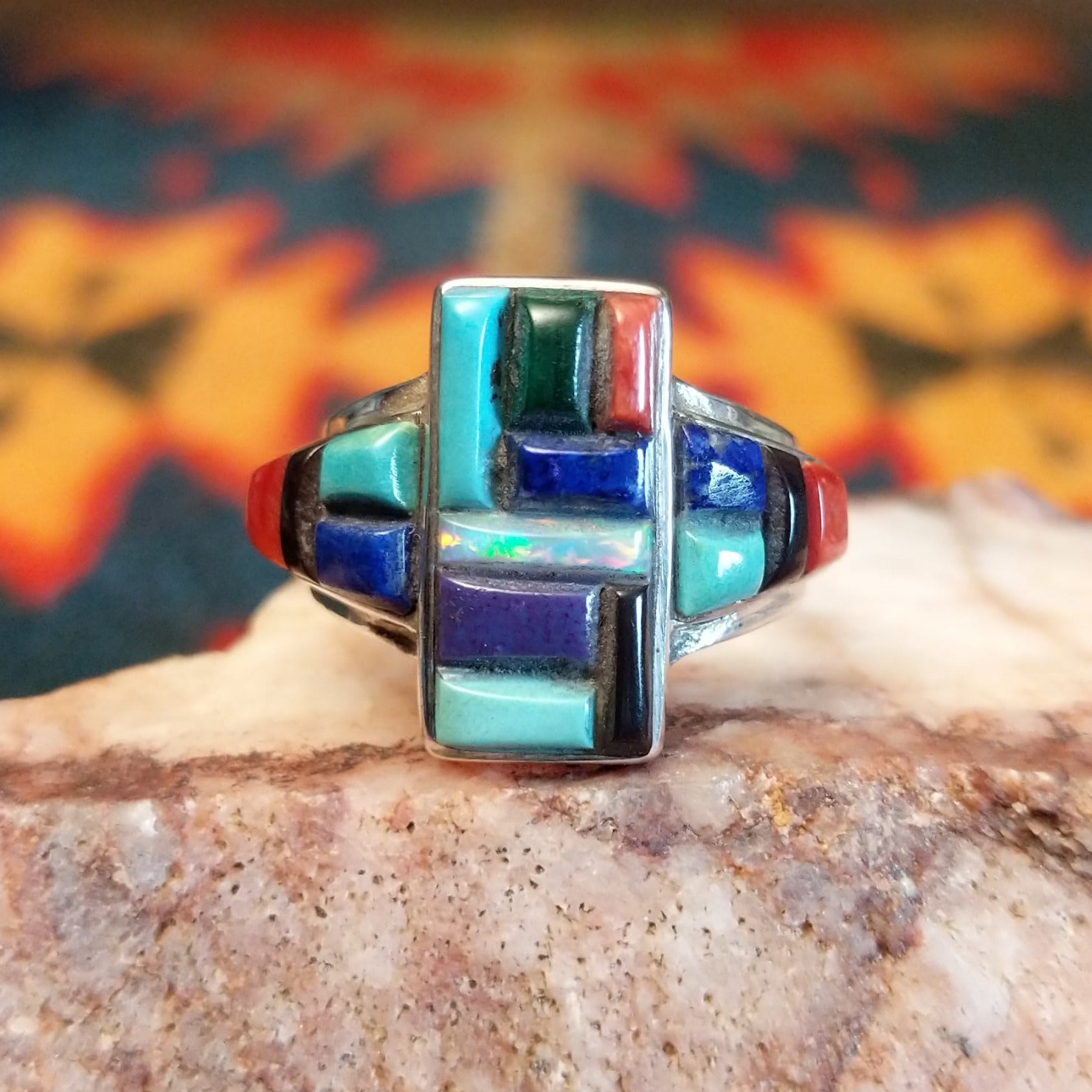 Chunky sterling silver ring featuring multi-stone inlays.