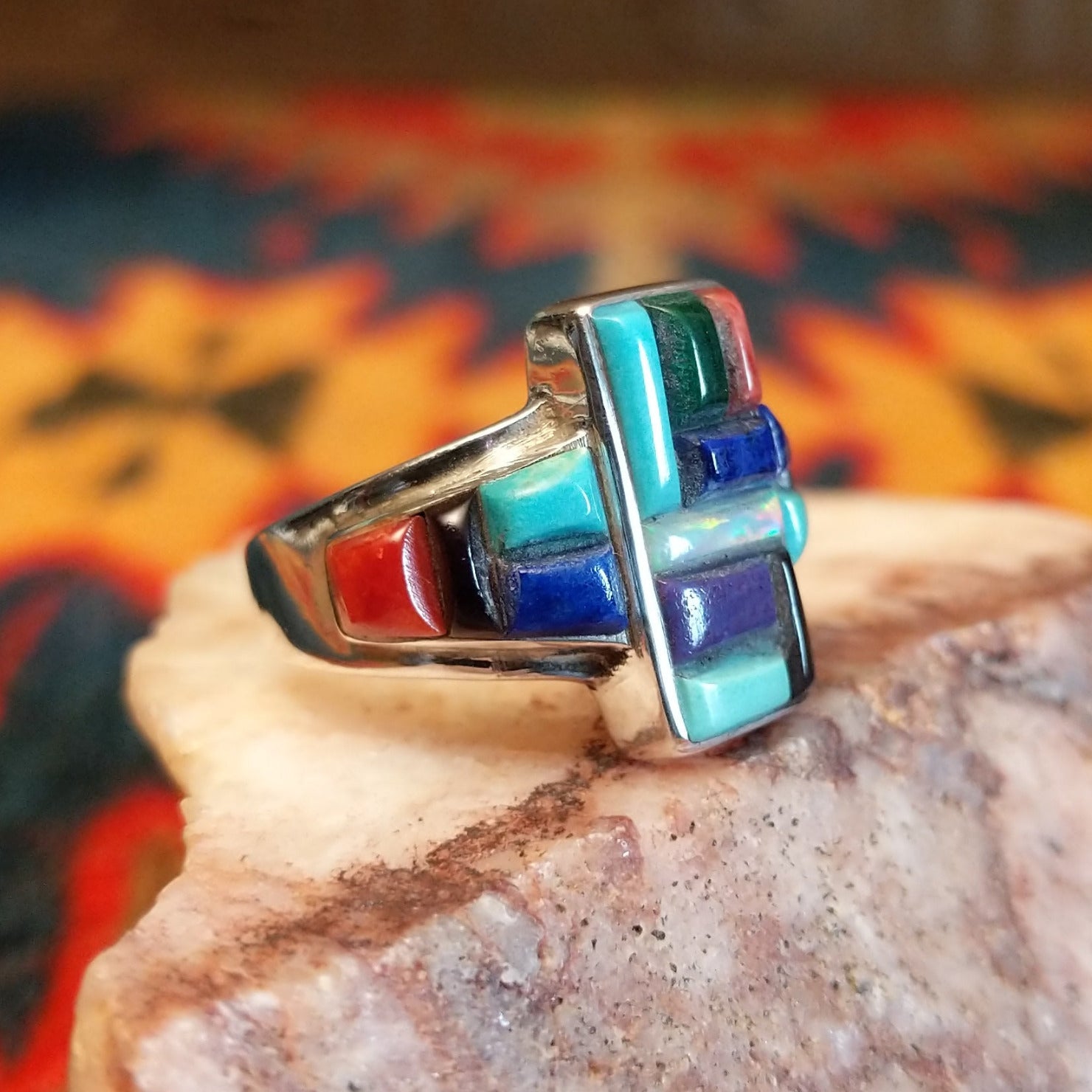 Chunky sterling silver ring featuring multi-stone inlays.