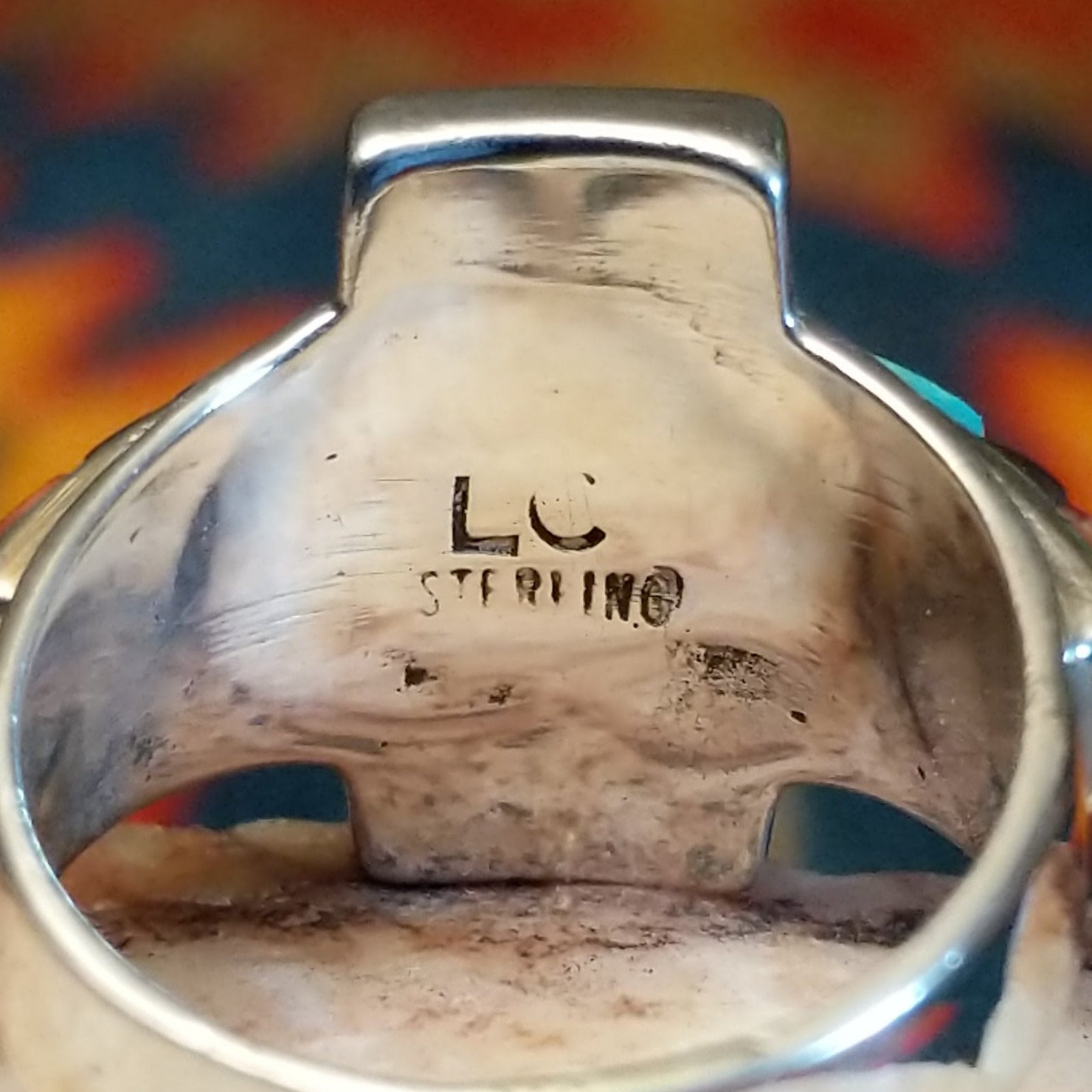 Close-up of the artisan's stamped signature.