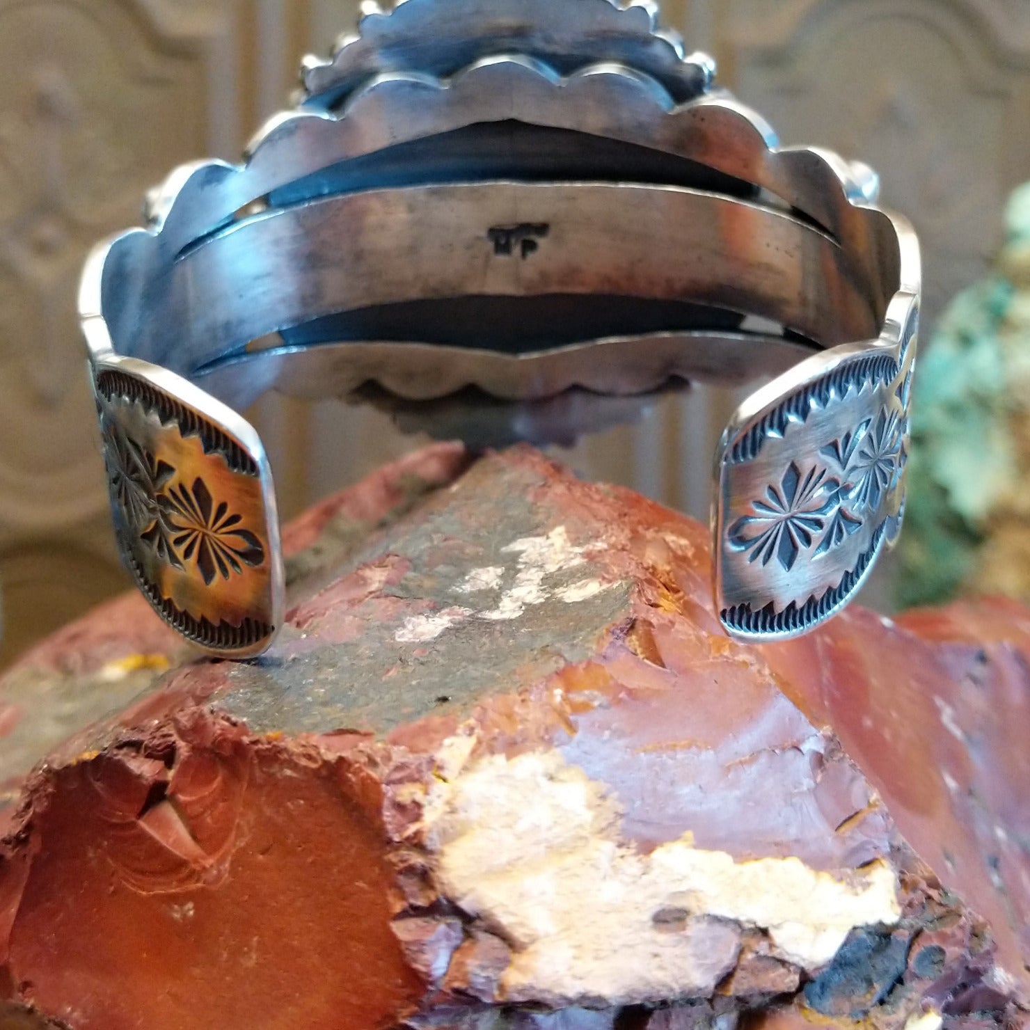 Sterling silver cuff bracelet with multistone assortment set in various bezels, framed by twisted rope and dotted accents.
