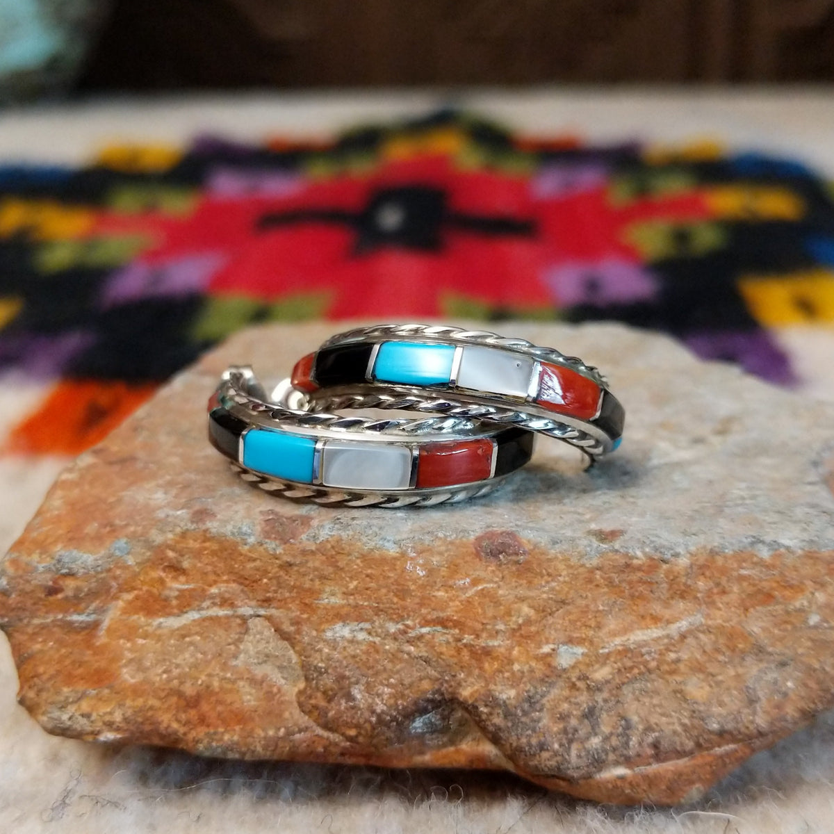 Multistone inlay hoop earrings by Malcolm Chavez with twisted silver borders.