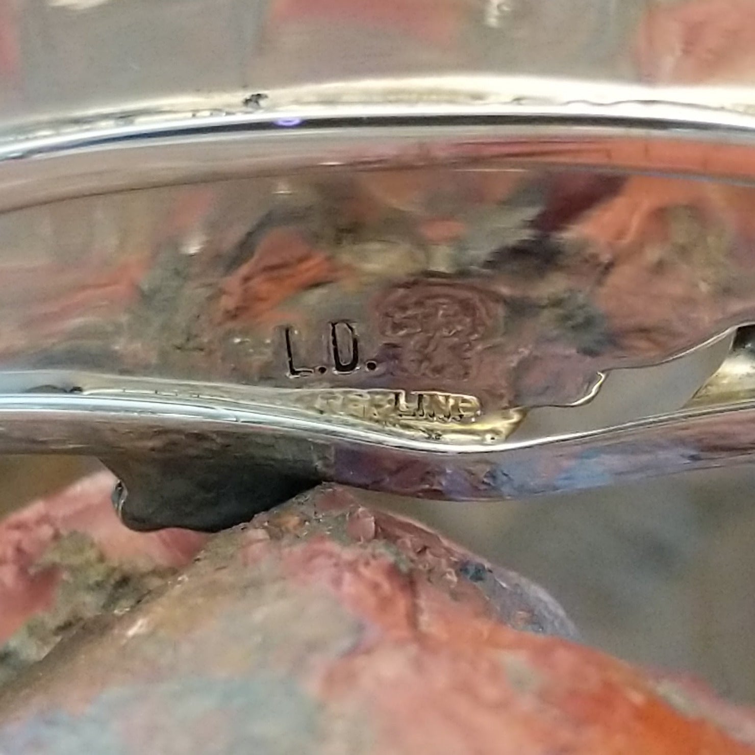 Close-up of the artisan's stamped signature.