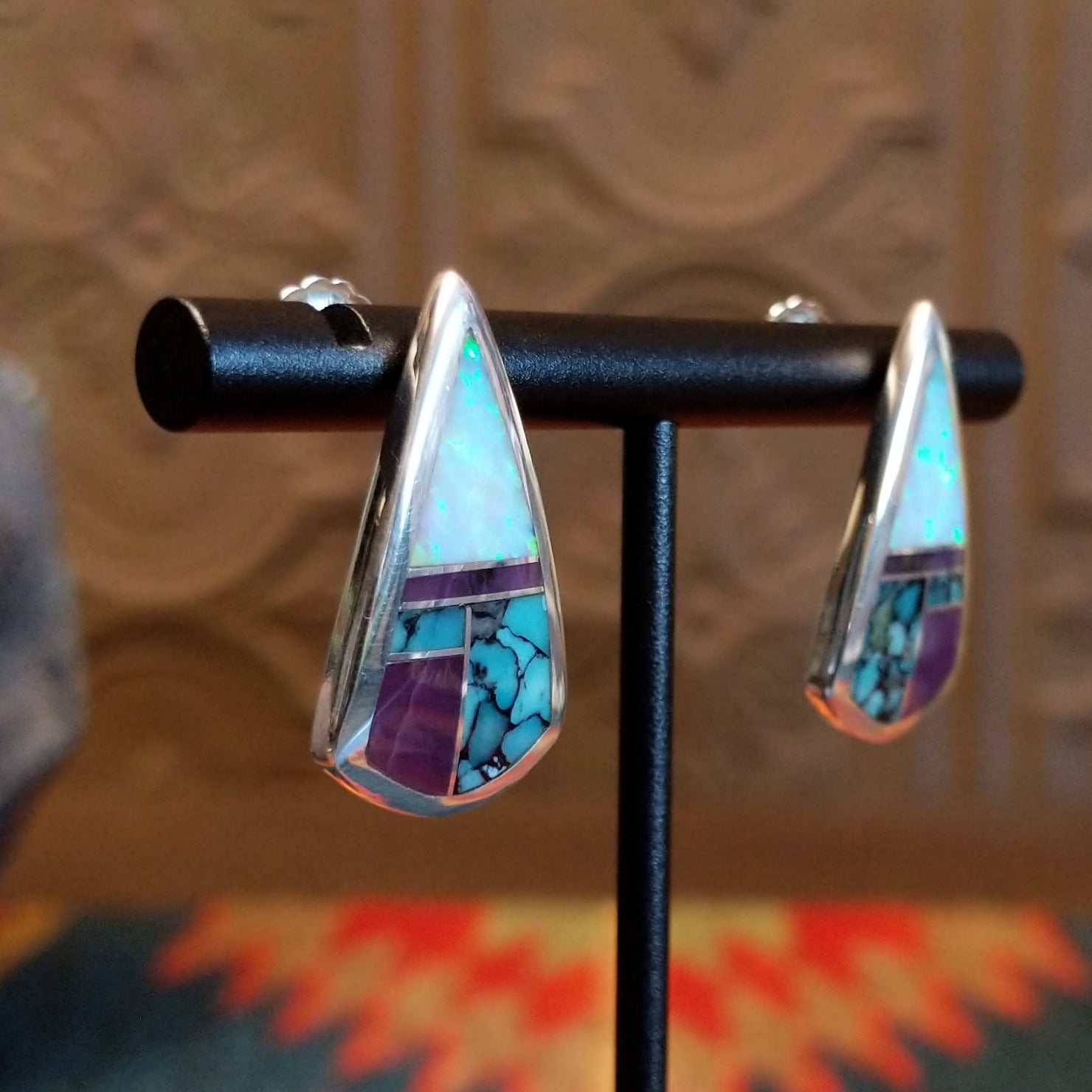 Sterling silver triangular earrings with multistone inlay set in the bezel.
