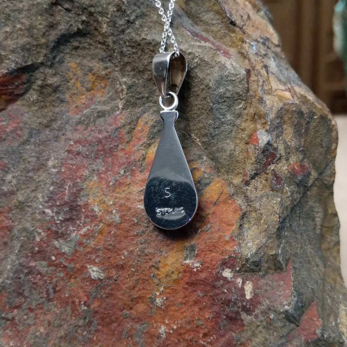 Multistone inlay teardrop pendant by P. Smith featuring turquoise, purple, orange, green, red, and blue stones arranged in a colorful geometric design; artisan and Sterling Silver stamp.