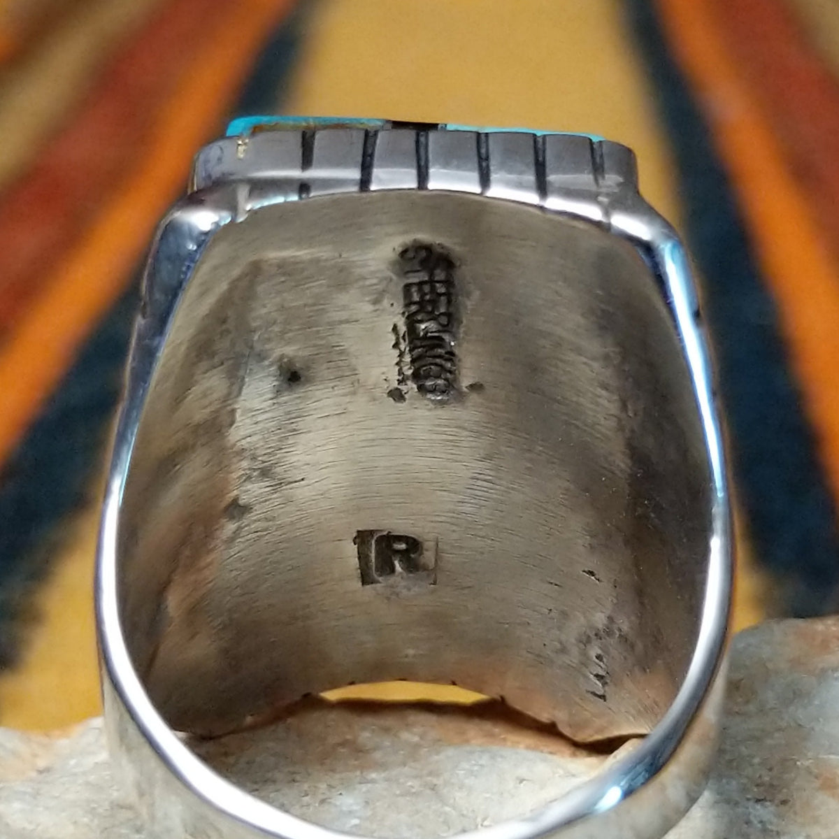 This vibrant Multistone Rectangle Inlay Ring by Wilbert Grey features a geometric arrangement of turquoise, coral, black, and white stone inlays set in a rectangular silver face with a detailed band; artisan and Sterling Silver stamp.