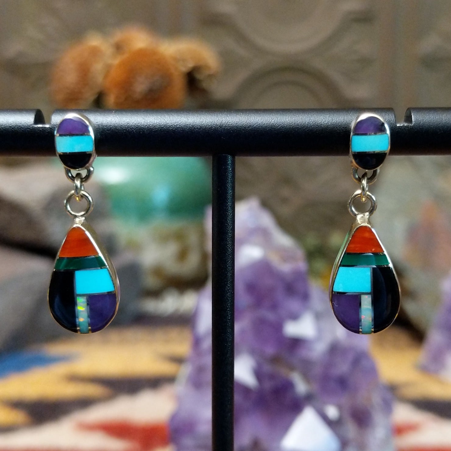 14kt gold Calvin Begay earrings with multistone teardrop inlay and oval tops.