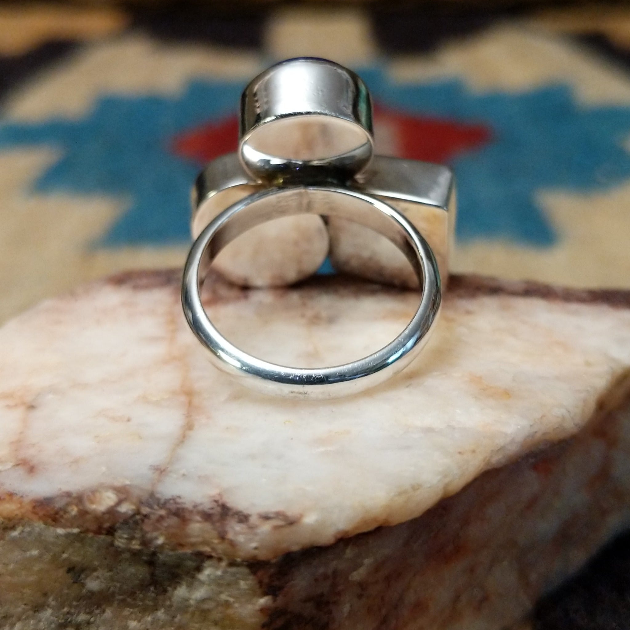 Multistone trio ring by Ann Curley, featuring blue lapis, green turquoise, and red spiny oyster shell set in a handcrafted sterling silver ring with a contemporary design. Underside view.