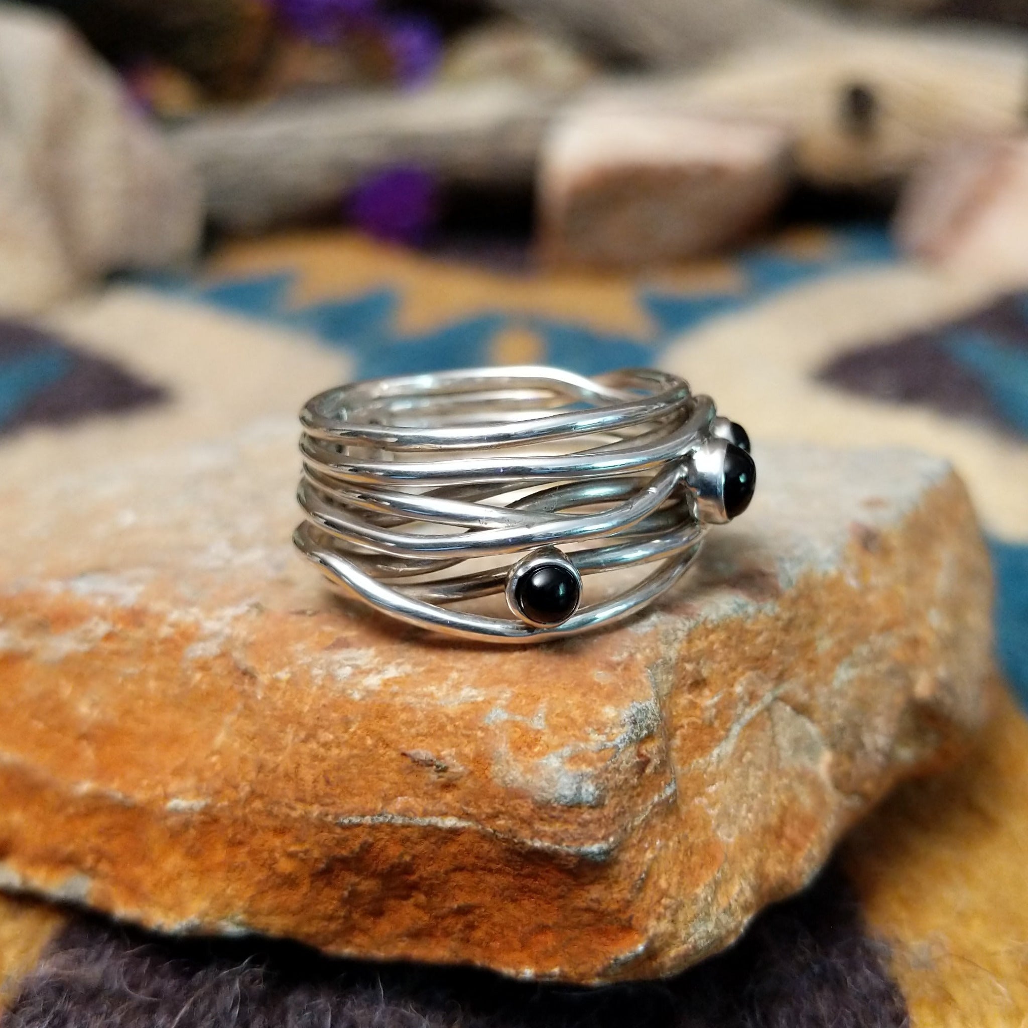 Navajo sterling silver multi-strand ring with polished Black Onyx cabochons; side view.