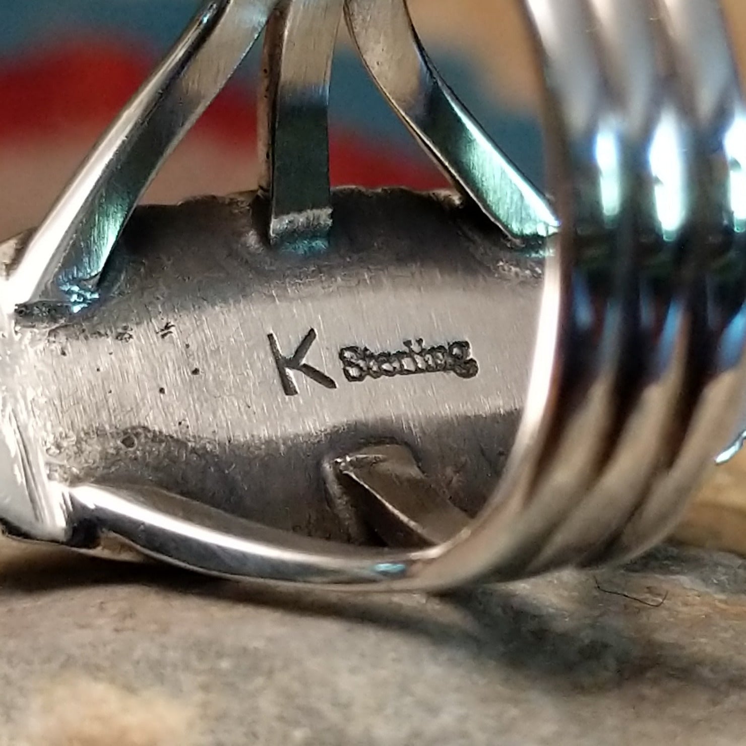 Close-up of the artisan's stamped signature.