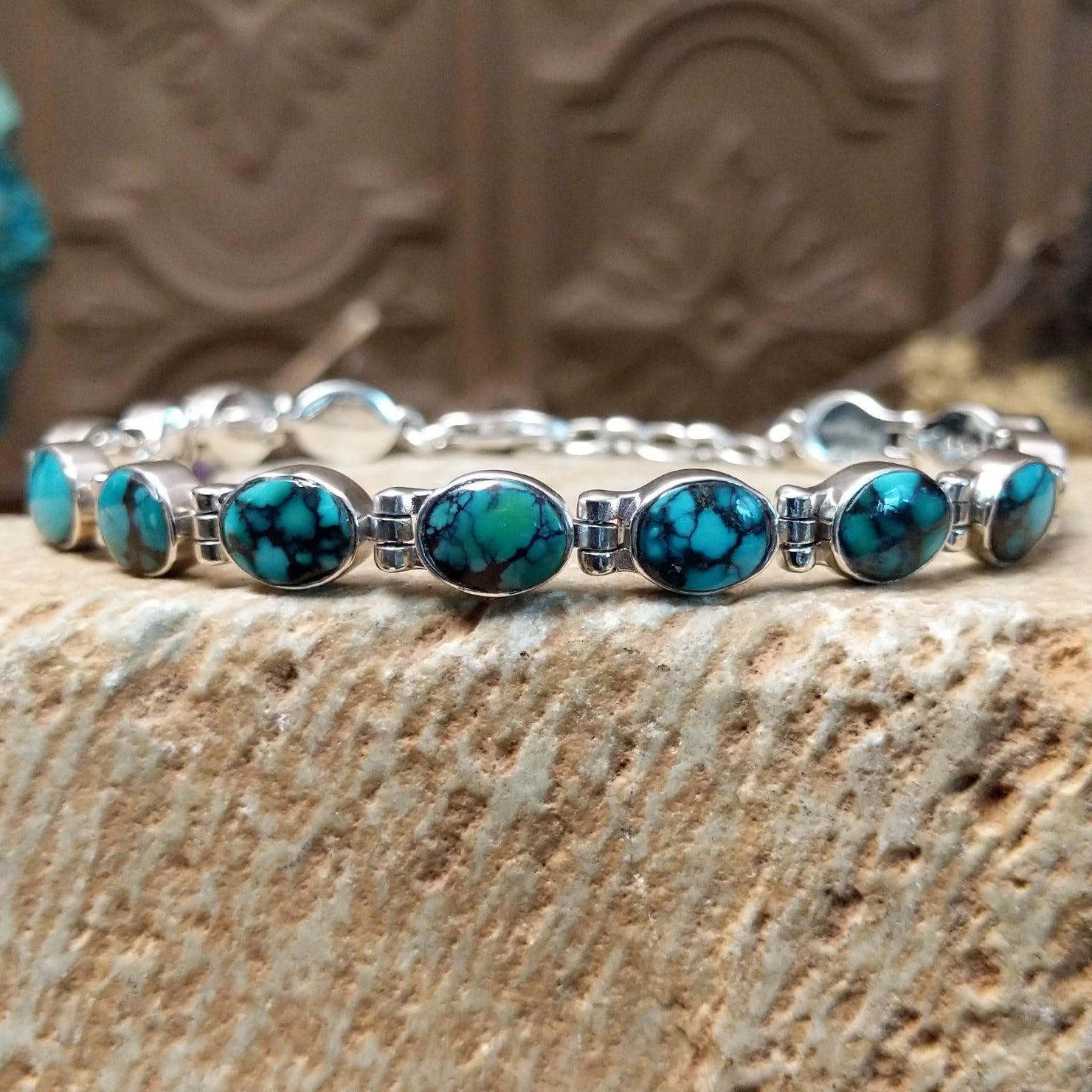 Sterling silver link bracelet with Chinese turquoise set in oval bezels.