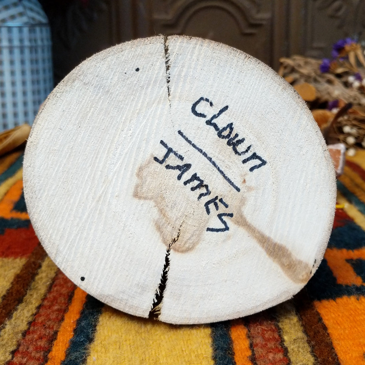 Underside of Navajo Ogre Kachina doll base with handwritten figure name and artist surname.
