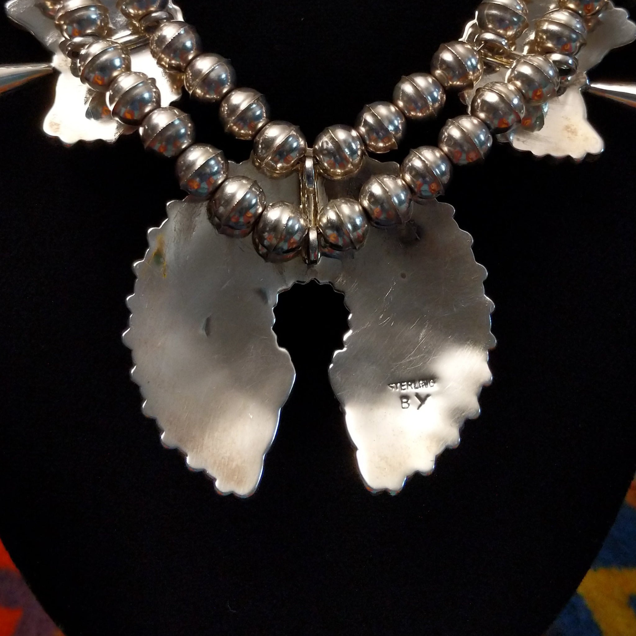 Artisan and Sterling Silver stamp on back of necklace.