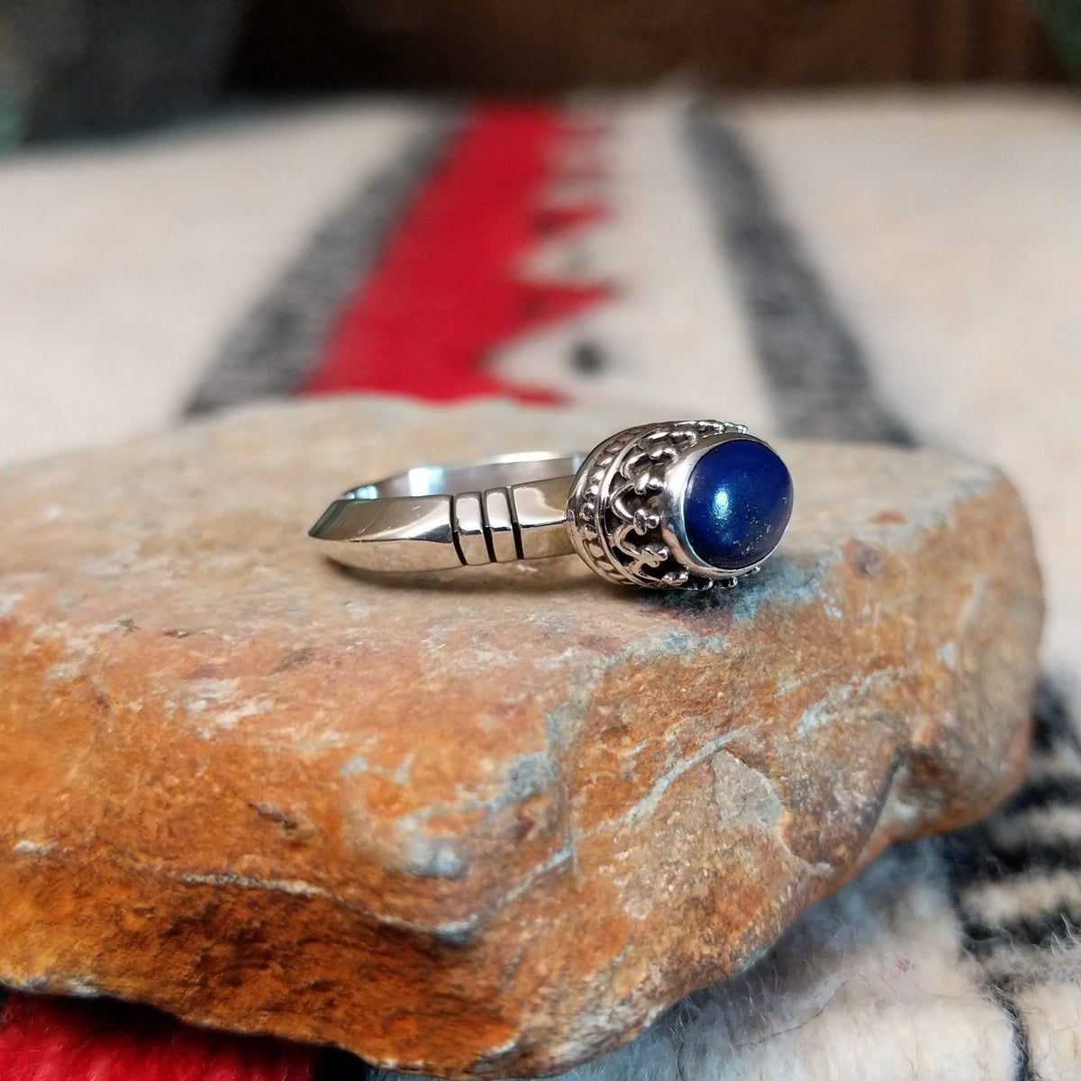 Navajo silver ring with lapis stone and ornate crown-style setting.