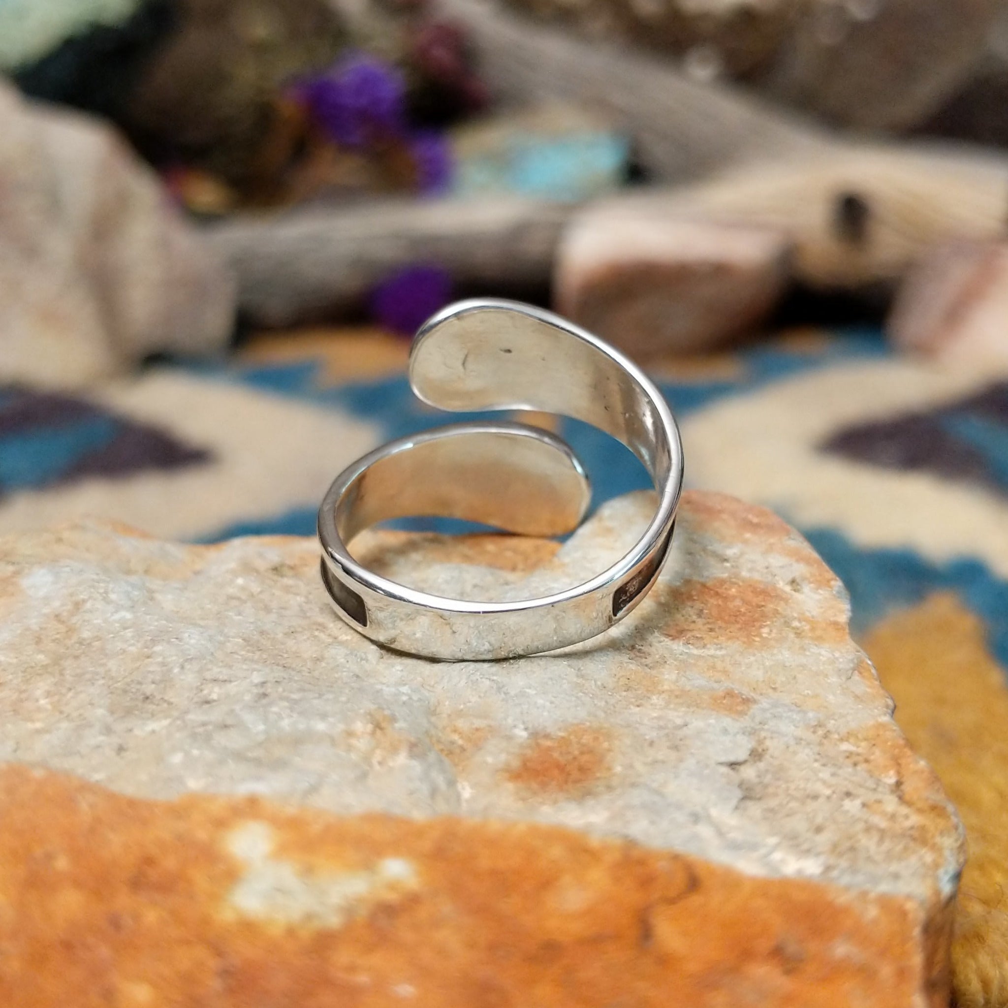 Handcrafted Navajo sterling silver bypass ring featuring graduated polished silver domes set in oxidized open-ended bezels, creating a modern Southwestern statement design; underside view.