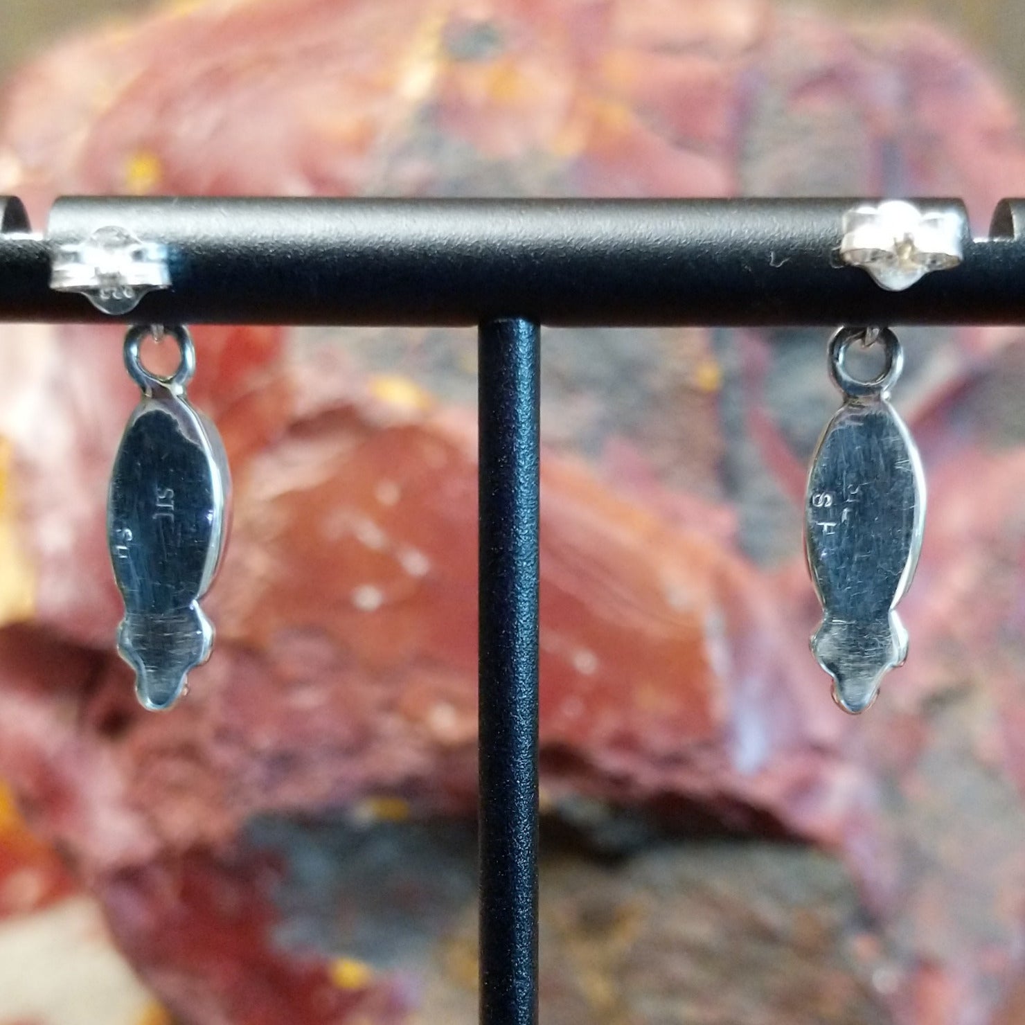 Sterling silver post earrings with lapis set in the bezels, framed by dotted accents.