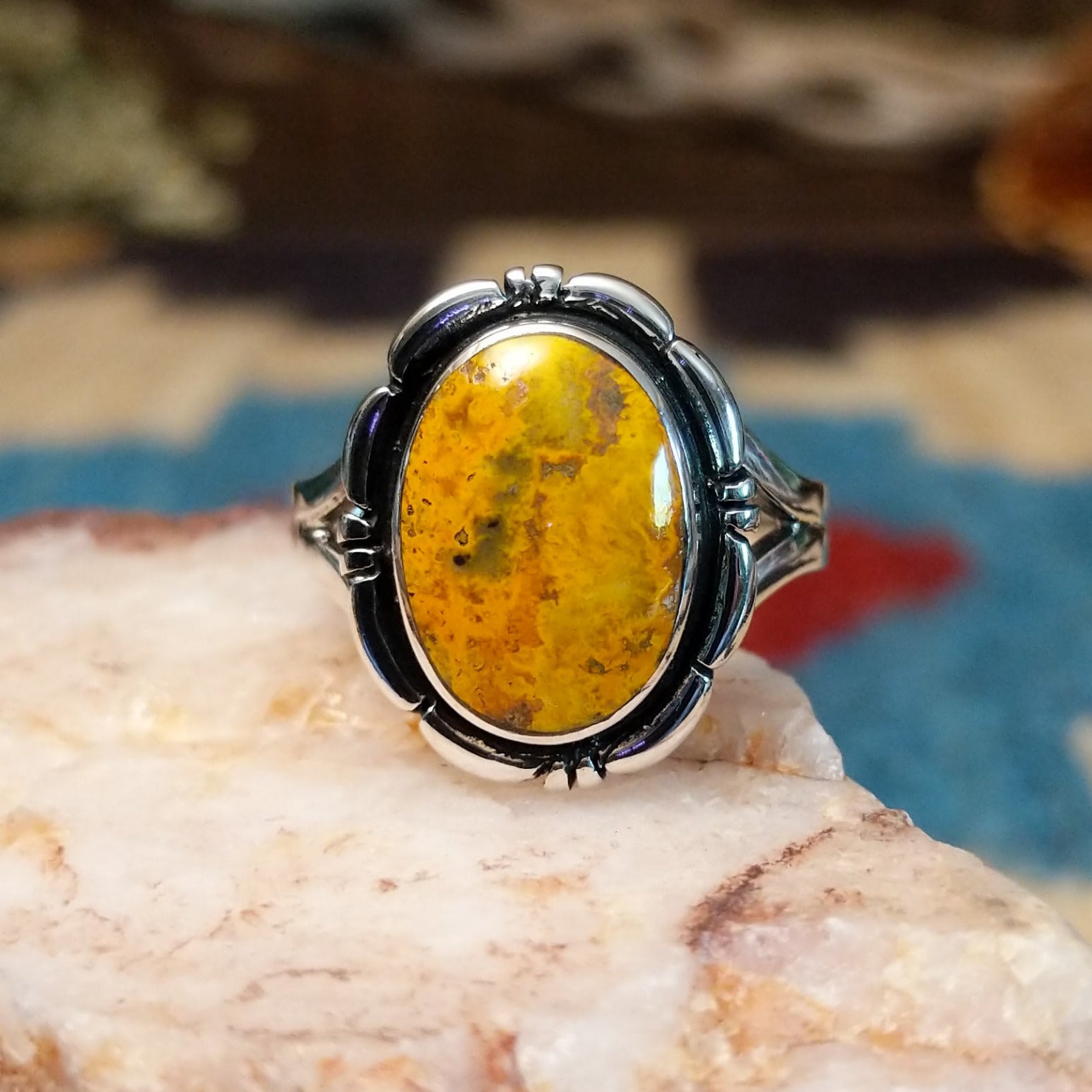 Sterling silver ring with bumblebee jasper set in the oval bezel, framed by the etched setting.
