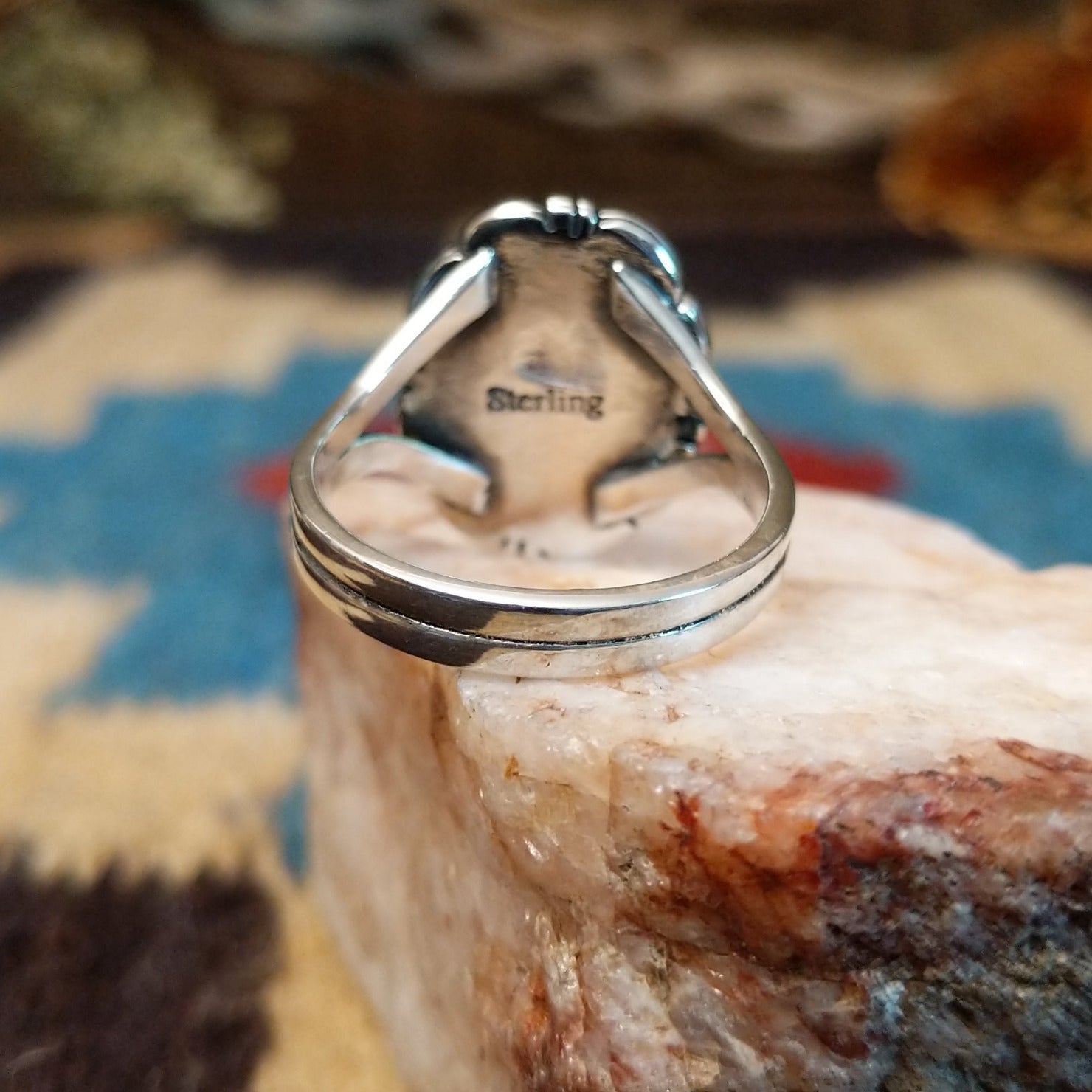 Sterling silver ring with bumblebee jasper set in the oval bezel, framed by the etched setting.
