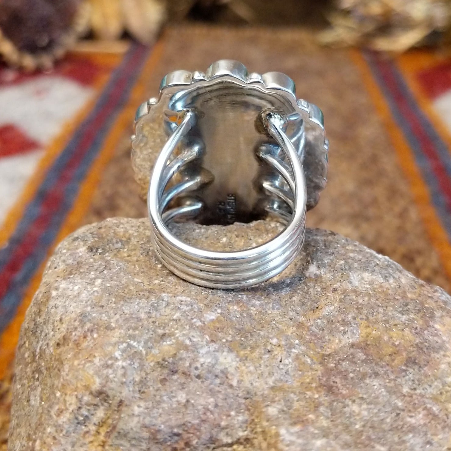 Sterling silver ring with coral set in the bezels creating a floral like motif and twisted rope accents around the center bezel.