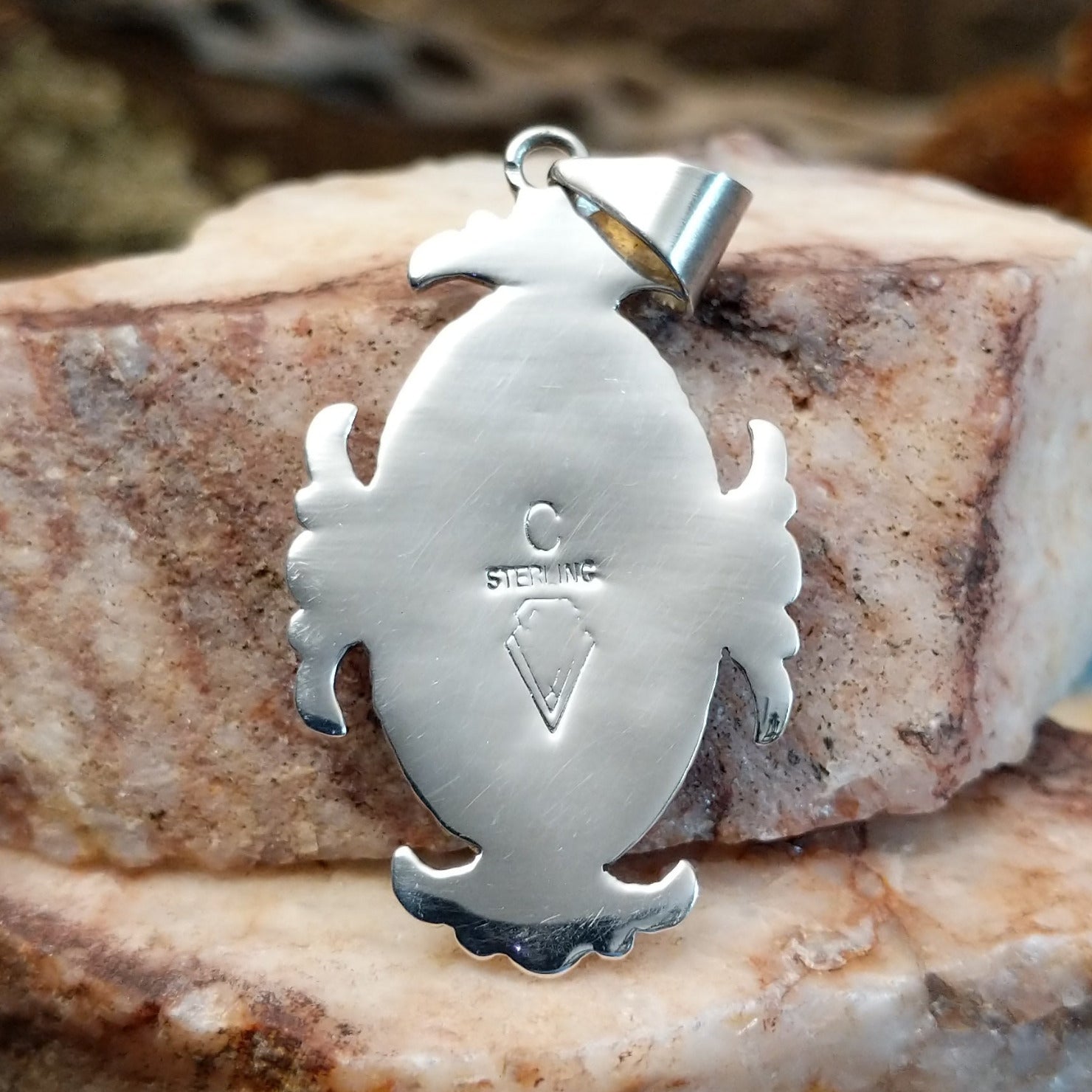 Close-up of the artisan's stamped signature.