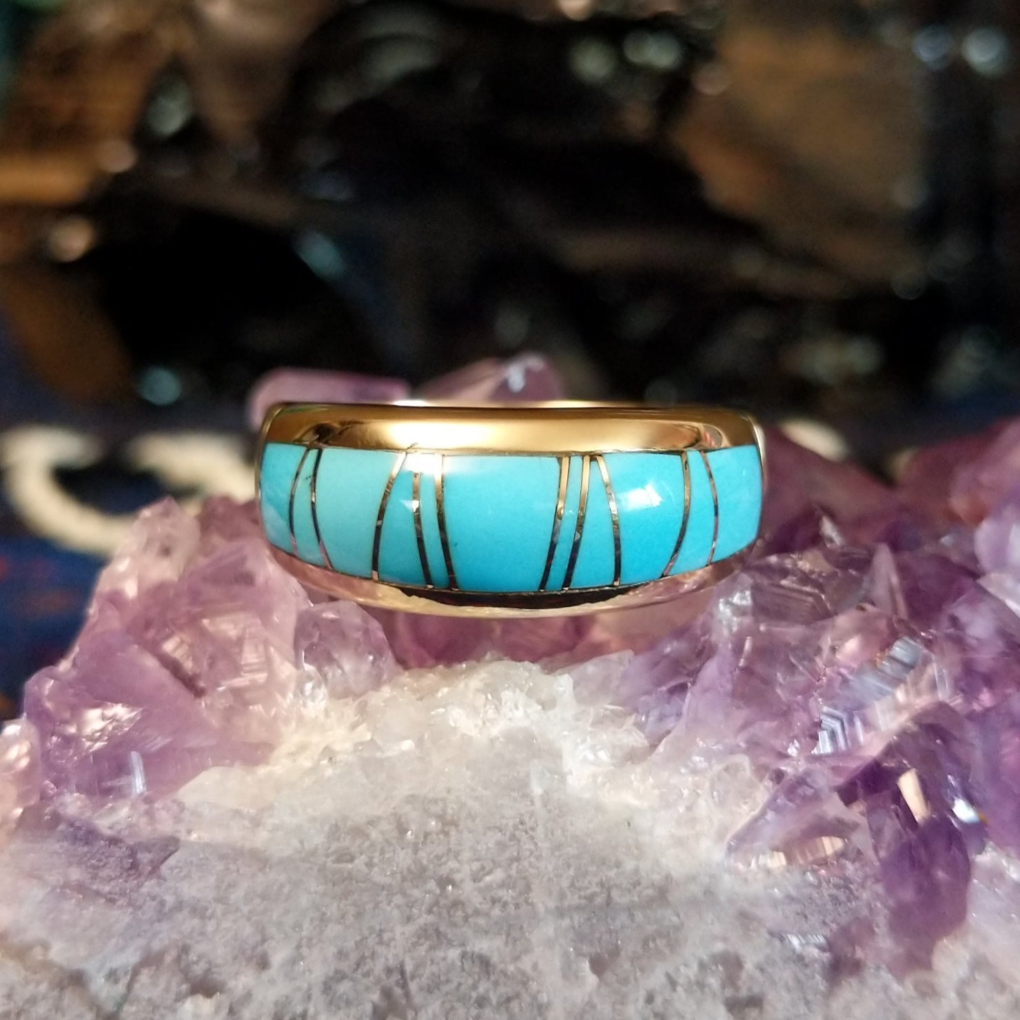 Gold band ring featuring a smooth turquoise inlay set in 14k gold.