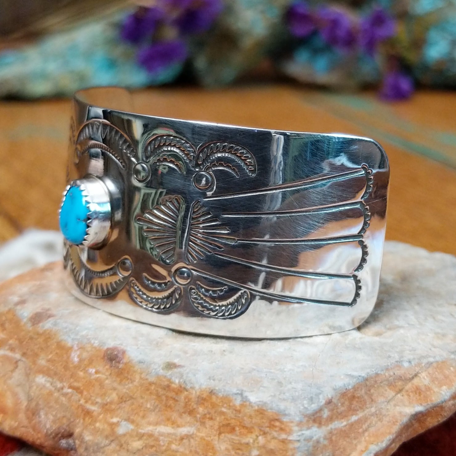 Sterling silver Navajo barrette with hand-stamped design and centered turquoise stone.