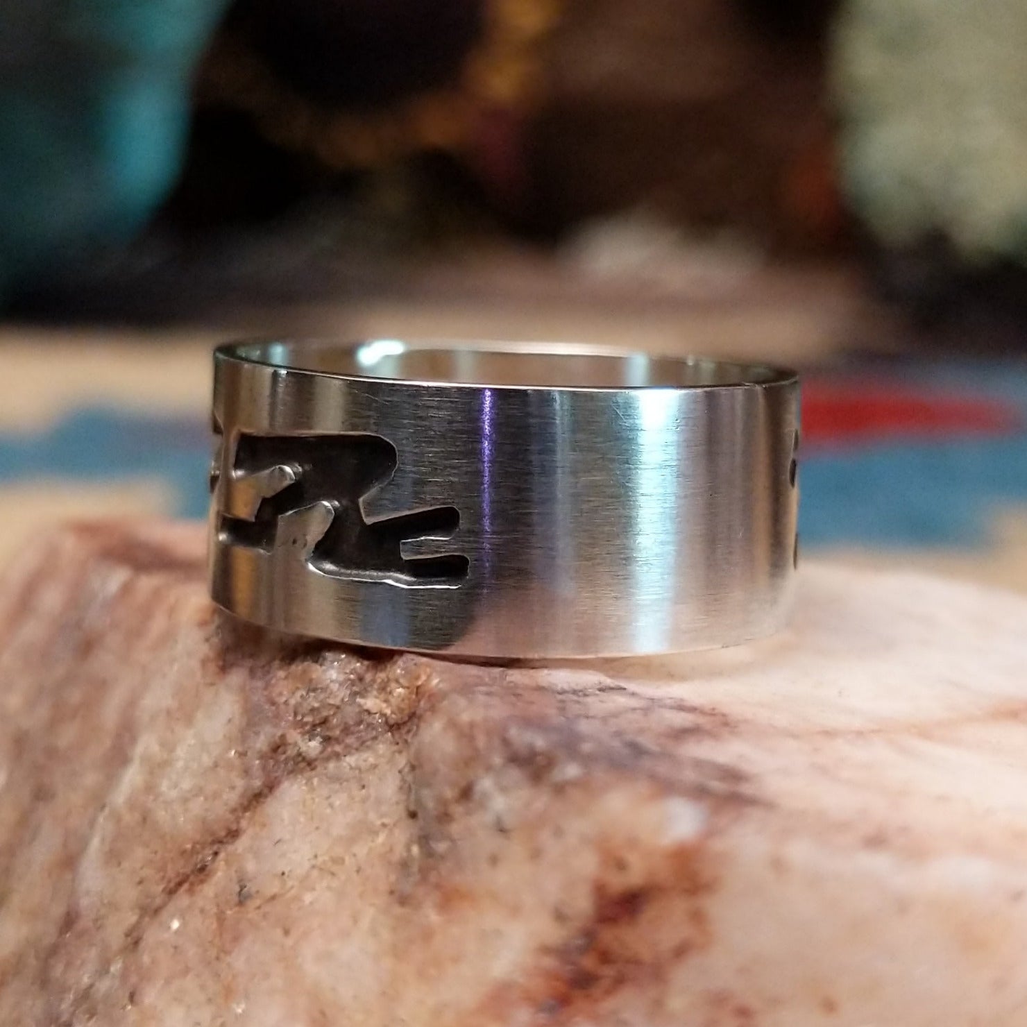 Solid sterling silver ring with Navajo-inspired designs.