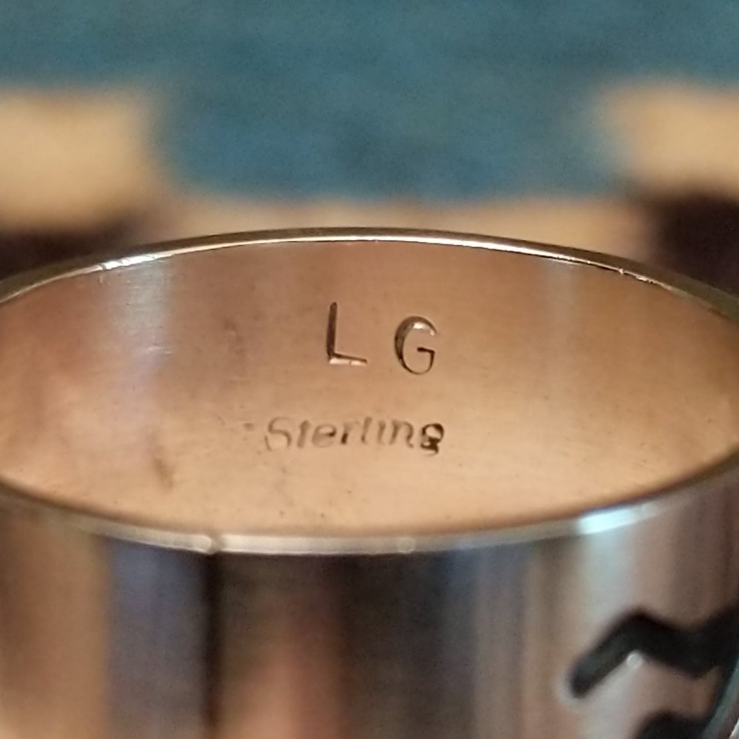 Close-up of the artist's stamped signature.
