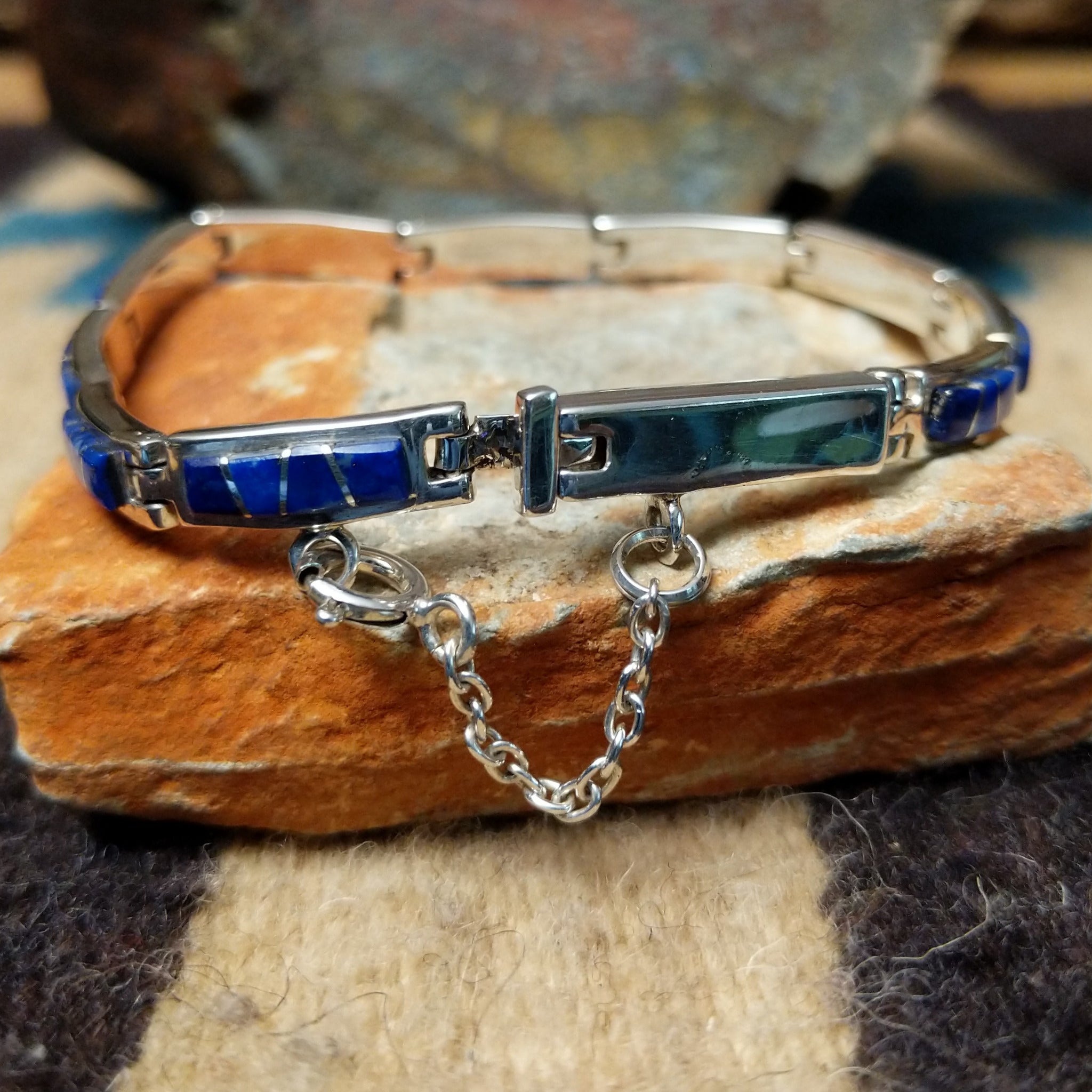 Navajo lapis inlay link bracelet with deep blue lapis set in handcrafted sterling silver; clasp view with safety chain.