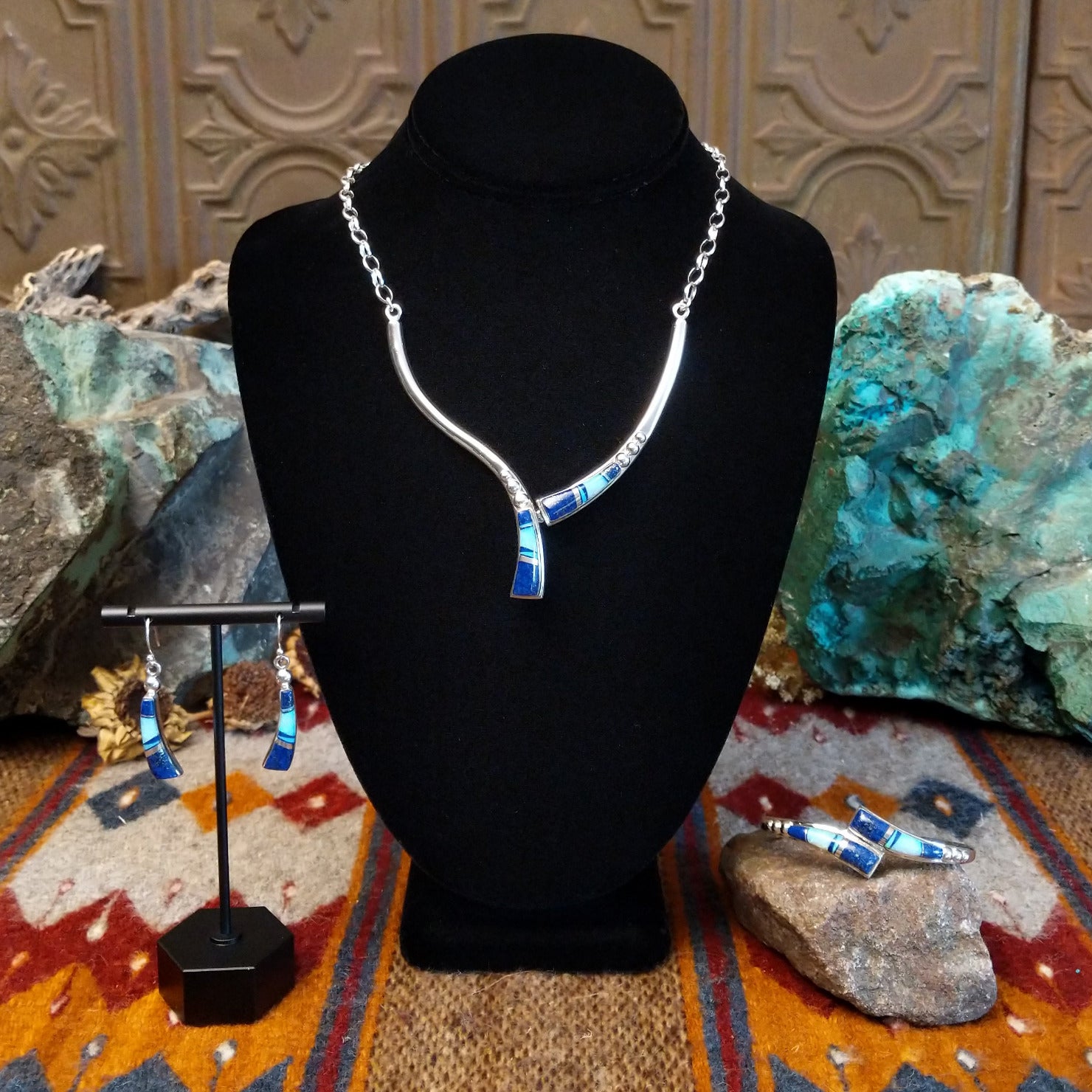 Flowing jewelry set with matching necklace, earrings, and cuff featuring lapis and manmade opal inlays.