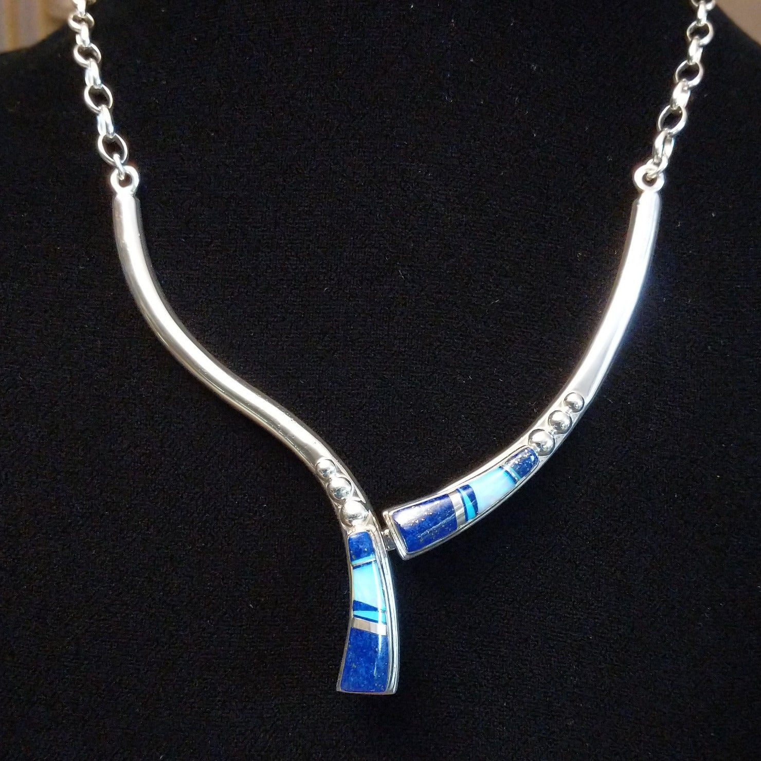 Flowing jewelry set with matching necklace, earrings, and cuff featuring lapis and manmade opal inlays.