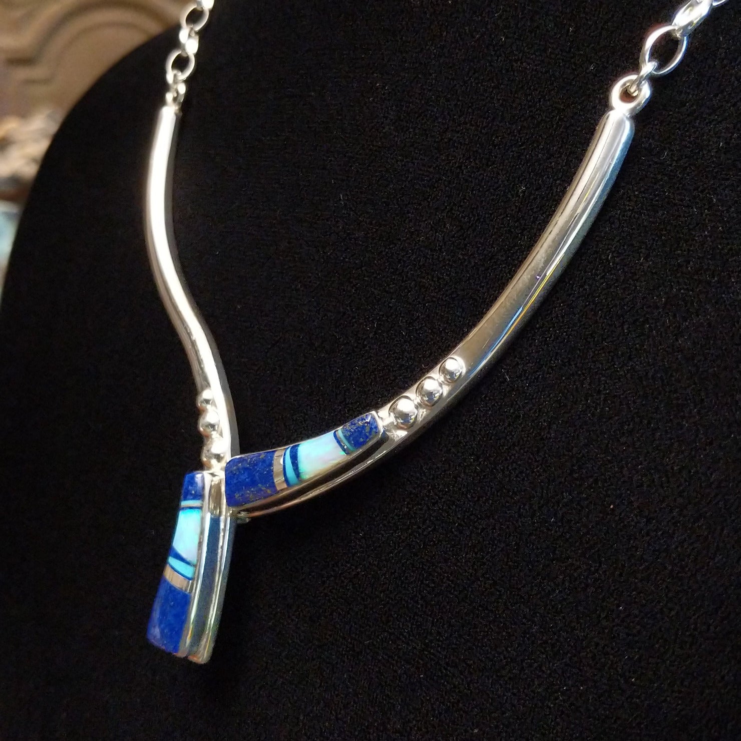 Flowing jewelry set with matching necklace, earrings, and cuff featuring lapis and manmade opal inlays.