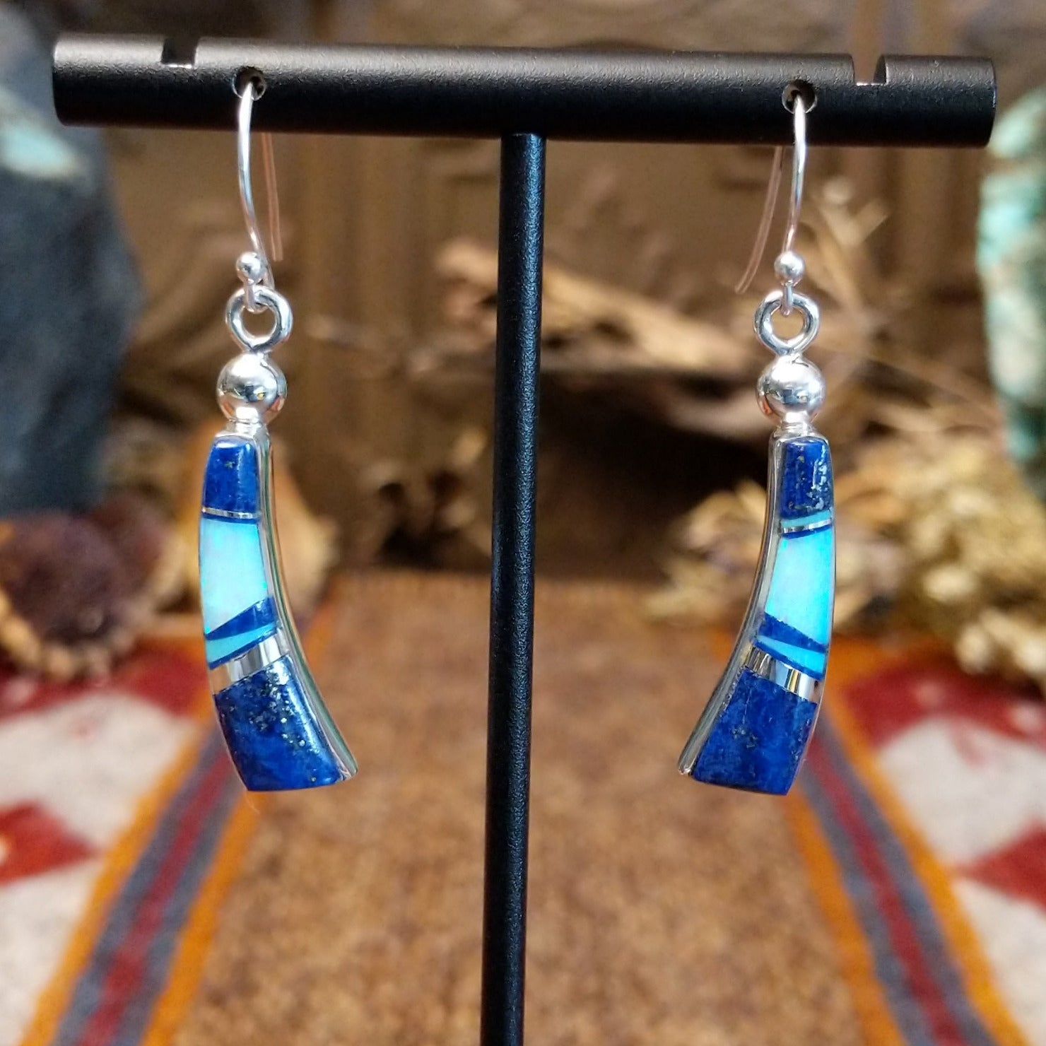Flowing jewelry set with matching necklace, earrings, and cuff featuring lapis and manmade opal inlays.